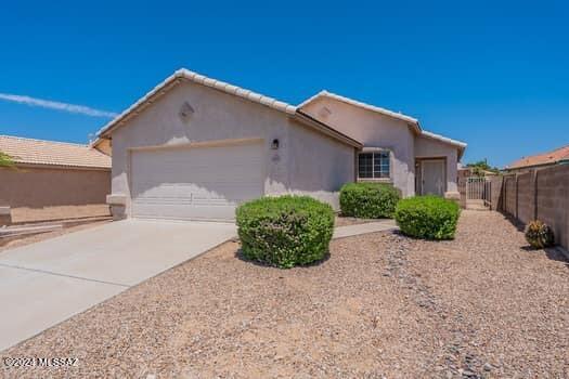 2 bedroom, 3/4 bath, single family home in the Suncrest Subdivision!  New window screens, bathtub replaced with shower, home and carpet professionally cleaned.  Open concept living space, carpet and ceramic tile floors.  Stainless steel kitchen appliances, plenty of counter and storage space, laundry facilities in the garage.  Home is conveniently located between Cortaro Rd and Ina Roads making access to shopping, dining and commuting a breeze!