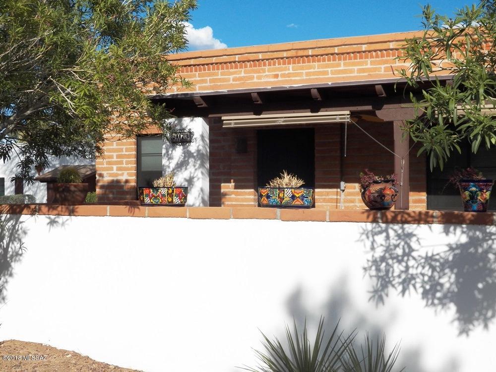 Top-of-the-line 2BR villa set back from a circular greenbelt, near the community pool. Less than 2yr old full-size Stainless Steel refrigerator, 5 burner gas range, dishwasher and microwave. Newer trac lighting, counters and cabinets complete this kitchen. Partially furnished interior painted in 2017. Easy care 100 percent tile floors. New dual-pane windows. Not one but 2 storage sheds plus stacked W/D. Use the nearby laundry facility for cumbersome bedding and quilts. Wrought iron security doors, front and back, with matching gate opening to a lovely, bricked patio overlooking front common area.