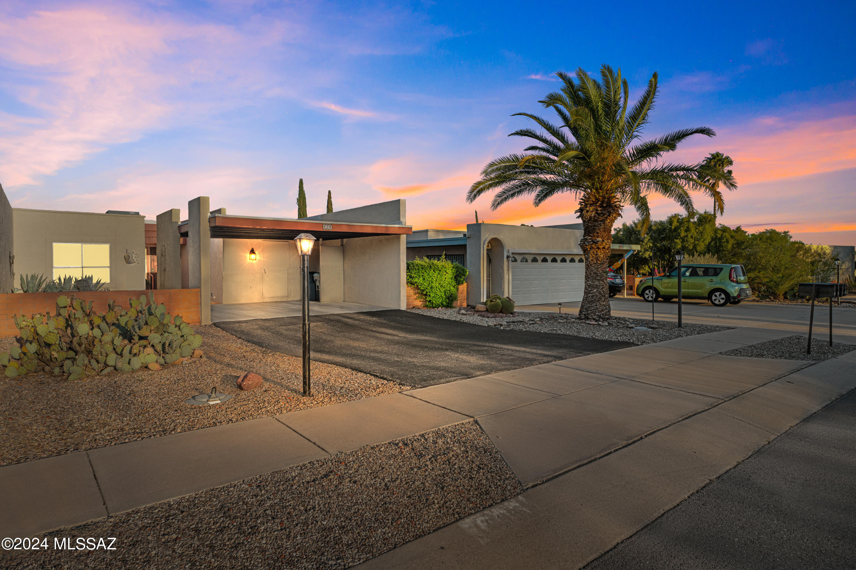 Wonderfully located and fully furnished townhome with amazing 180 degree views of the Santa Cruz Valley and surrounding mountain ranges. The view must be seen in person it is much better than pictures can show. The city lights of Tucson are visible at night and there are amazing views of the Santa Ritas and Madera Canyon. The natural desert space directly behind the property is maintained by the HOA. The AC unit was replaced in 2018 and the roof was just recoated in 2022. There is new tile in the bathrooms and hallway. The popcorn ceiling has also been removed and the interior was recently painted. There is a 2 car carport with an additional storage room. The backyard of this property is facing east so you will get morning sun and be able to enjoy the amazing Arizona sunsets in the evenin The neighborhood pool and pickleball courts are just around the corner and GVR membership is available but not required!
