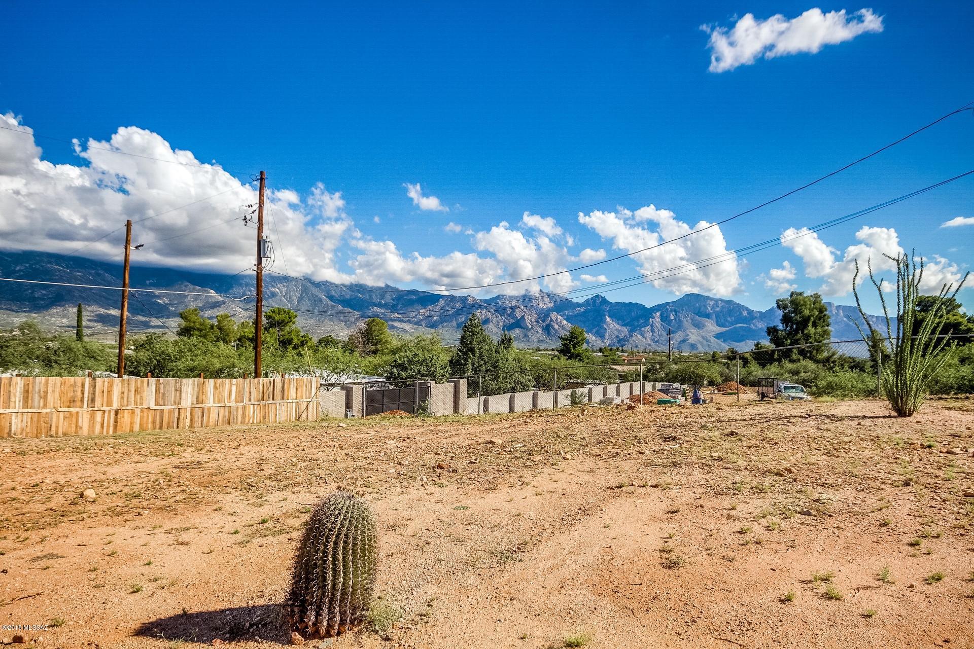 This lot is ready to go!! Previously had a mobile home on it so the land has been leveled & water & electric are metered and septic is on-site! Just over an acre, zoned for horse property, w/ GORGEOUS unobstructed mountain views and backs up to a wash so you won't have to worry about neighbors behind you. It has been recently cleared and thoughtfully landscaped. This completely fenced lot features a brand new 6-foot fence w/ a gate that leads to the wash behind the property. No road maintenance agreement on record. Cash or Conventional financing. The possibilities are endless!! Septic Recertified when they purchased in 2017,  Water, gas, & septic are at the pad. Electric can run from the old pole or a new one ran from the new transformer installed at the street.