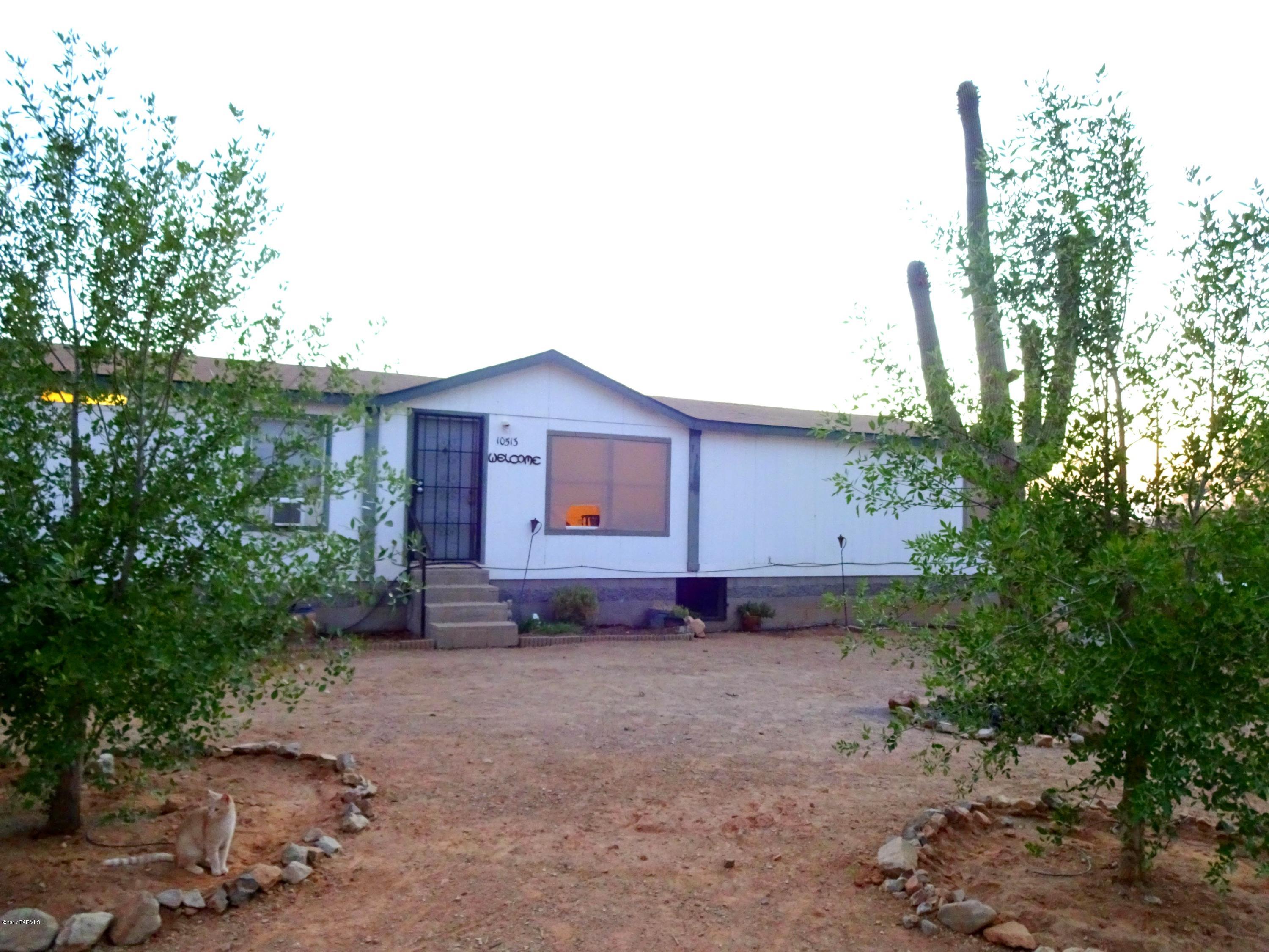 Country living on 4 acres just 30min from down town Tucson and in the Marana school district!  Large home featuring a split floor plan and two living areas! Big master bedroom with walk in closet, on suite has shower, garden tub, and double vanities. Fully fenced property has mountain views, beautiful saguaros, and mature trees throughout. Saguaro national park starts at the end of the street!