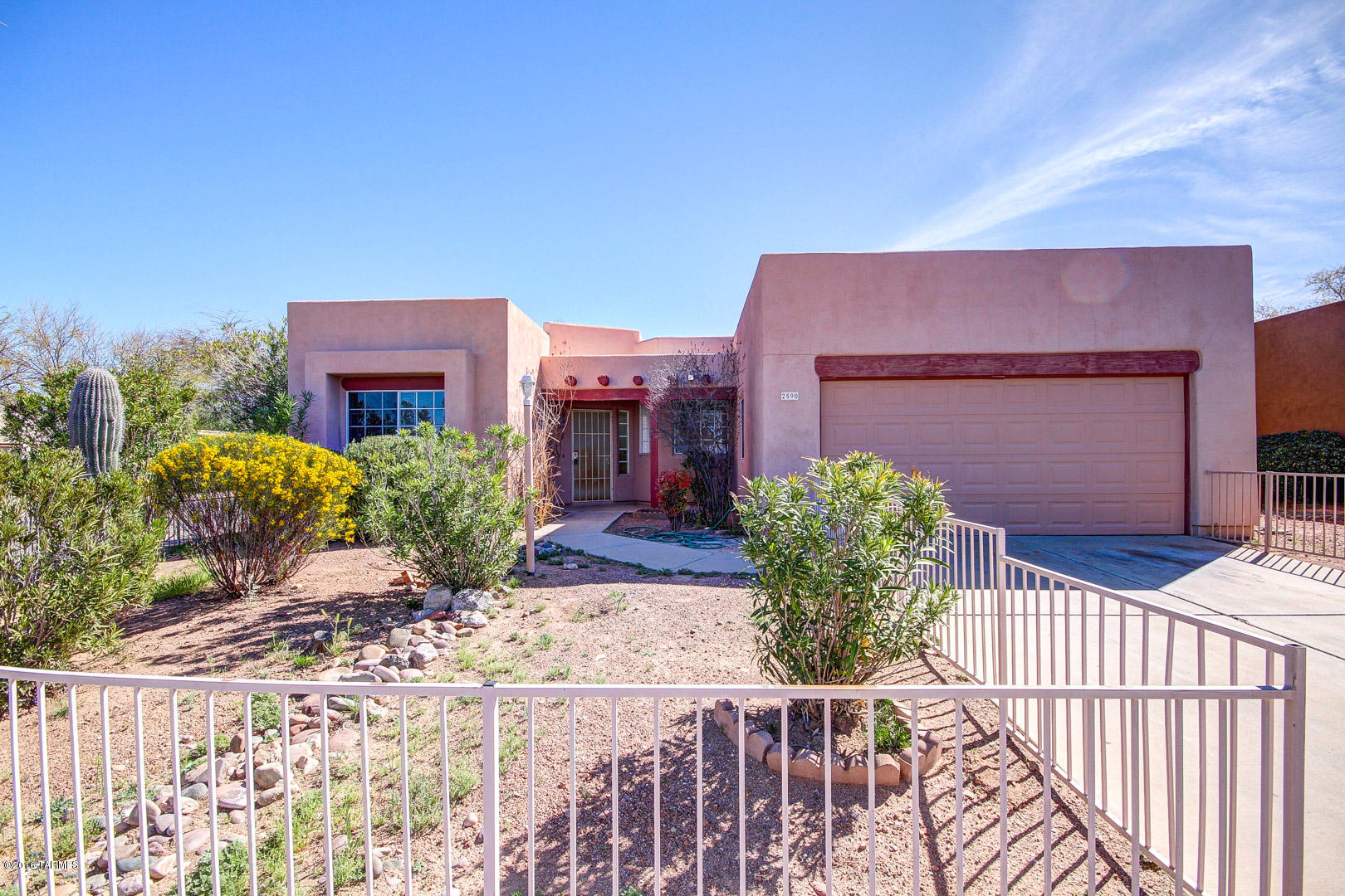 Spacious open floor plan Home with great curb appeal and move-in ready. Soaring ceilings, cozy fireplace, ceiling fans, large windows, plush carpet, Arcadia Doors to patio, and saltillo tile in all the right place. Fantastic chefs kitchen features tiled counters, great views, and plenty of wood cabinets. Patio access from master retreat with private en suite. Extended backyard covered patio and endless blue skies. Close to Park. A must see charming Home.