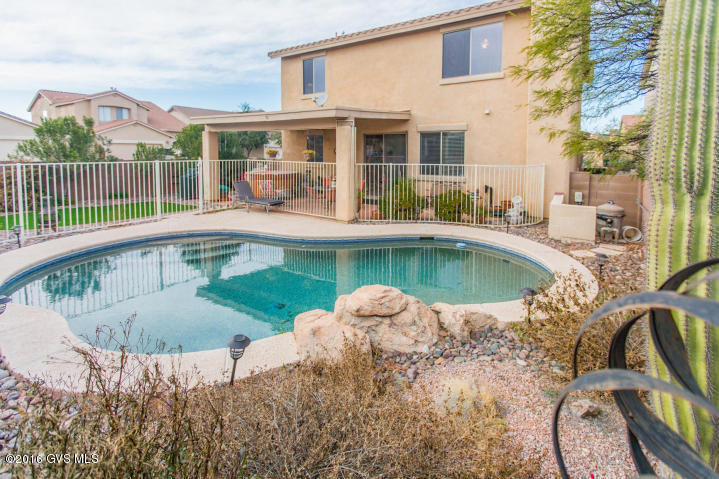 Your Dream Home Awaits! Lovely backyard oasis with sparkling pool, faux lawn and hot tub; this STUNNING Saguaro Model by Insight Homes has everything your heart desires! Beautifully upgraded! As you enter, notice the sweeping staircase and soaring ceilings in the Formal living and dining room, with custom wood doors on TV niche. The chef will love the granite counter tops, breakfast bar and upgraded cabinetry. Daily dining area opens to the Family Room with its cozy fireplace. Downstairs Bedroom and Full Bath. Upstairs, double doors open into the spacious master suite. Master bath w/separate garden tub and shower. Loft overlooks the formal areas below. 2 additional bedrooms and another full bath. Located on a CORNER LOT. Close to neighborhood park and all the Rancho Sahuarita amenities.