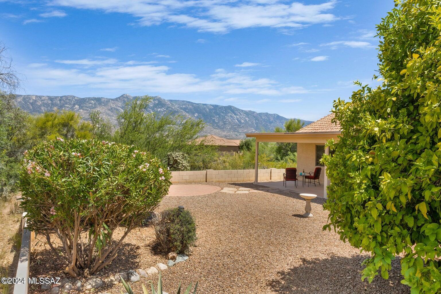 Step from your own backyard right onto the golf course and go for a scenic walk on the path before and after the golfers. This home offers beautiful mountain views  right from your doorstep and  backyard.  An inviting open floorplan adorned with real hardwood floors flows seamlessly throughout the main living areas.  The spacious great room is perfect for entertaining or relaxing with large windows that bathe the space in natural light.  There are more views from the open kitchen that is designed for both functionality and style.  The versatile den offers endless possibilities from a home office to a cozy reading nook.  This Laredo model provides a split bedroom design to give privacy to you and your guests.   Come see this lovely home today!