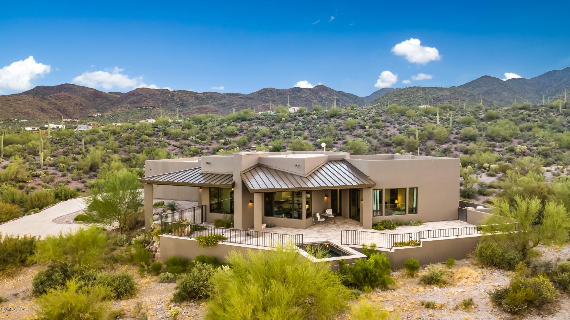 Stunning custom home with views of Downtown city lights and the mountains in every direction! Newly built in 2016 and situated on a private 2.1 acre lot. Huge picture windows show off the 360 degree views! Gated community & 3 Car Garage. Perfect open floor plan with great room open to kitchen and dining. Gourmet kitchen with leather finish granite, Thermador 6 burner gas range, wine refrigerator, classic white cabinetry, huge island, 2 sinks & stainless steel appliances. Perfect balance of modern with elegant details throughout. Gorgeous scored concrete floors throughout - no carpet! Low maintenance yard with travertine pavers and pebble-tec heated jetted spool. All around perfect home, this one is a must see!