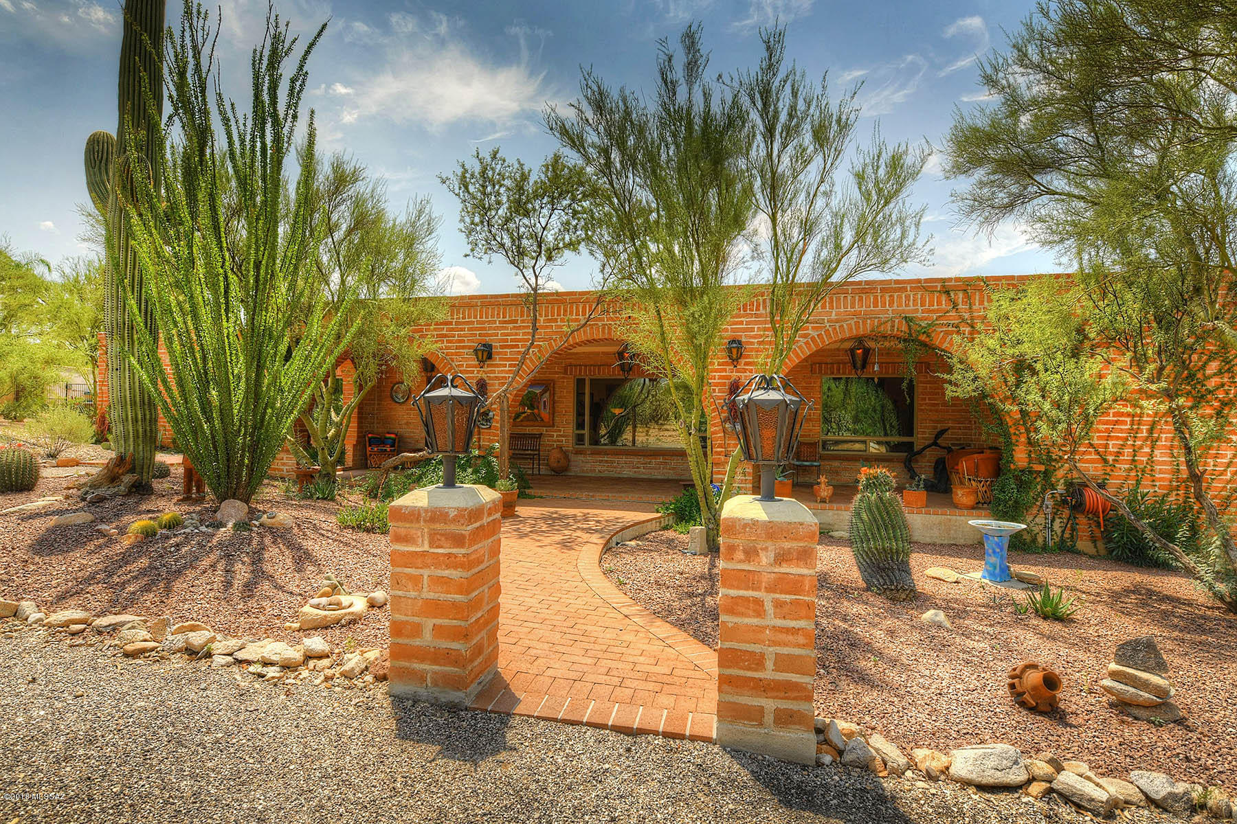 CLASSIC BURNT ADOBE HACIENDA STYLE HOME with MODERN UPDATES THROUGHOUT! Private Tanque Verde Vista SINGLE STORY home 1.13 acre. QUIET SETTING IN CONVENIENT LOCATION! Beautiful natural desert vegetation, quiet with mountain views. REMODELED kitchen (w/ granite & SS Appliances) & baths, new low ''E'' windows throughout, new flooring in living room, freshly painted, much work done in the yard to make it a perfect retreat. 4 bedroom w/ 3 baths & split floor plan. Private guest quarters w/its own bath, fireplace & separate entrance. Large master suite w/fireplace & access to pool. Open kitchen & family room boast fabulous beamed ceiling & fireplace. Incredible backyard w/pool & spa, covered ramada, built-in BBQ w/ cooking area, Kiva fireplace & more. Circle drive. Garage w/ WORKSHOP. NO HOA.