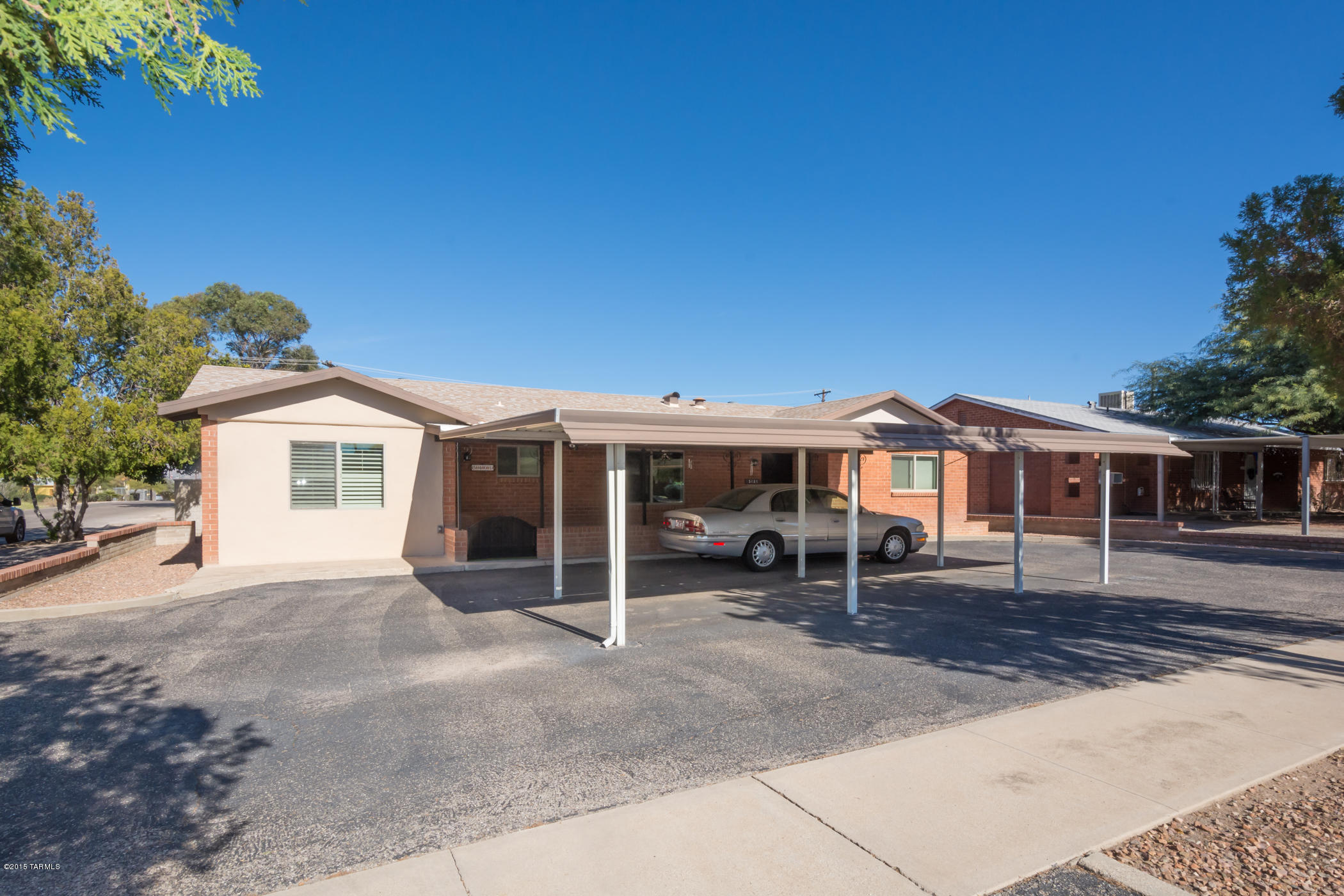 This lovely 1950’s “1 owner” charmer has been meticulously maintained, is located on a terrific corner lot & has something for everybody. Fabulous block walled-in backyard with large covered patio, lots of hardscape, grassy area, & built-in BBQ/firepit, perfect for entertaining. The car buff will be delighted with the double gated entry to the carport in the backyard with attached workshop & storage, not to mention the very large 2-car carport that fits closer to 4 cars.  Inside you will appreciate knotty pine cabinets, tile backsplashes, laminate flooring, dual pane windows with shutters, game room & ceiling fans throughout. All will appreciate the newer 19-seer A/C unit, hot water heater & upgraded electrical panel. Great central location convenient to shopping & dining. Come see t