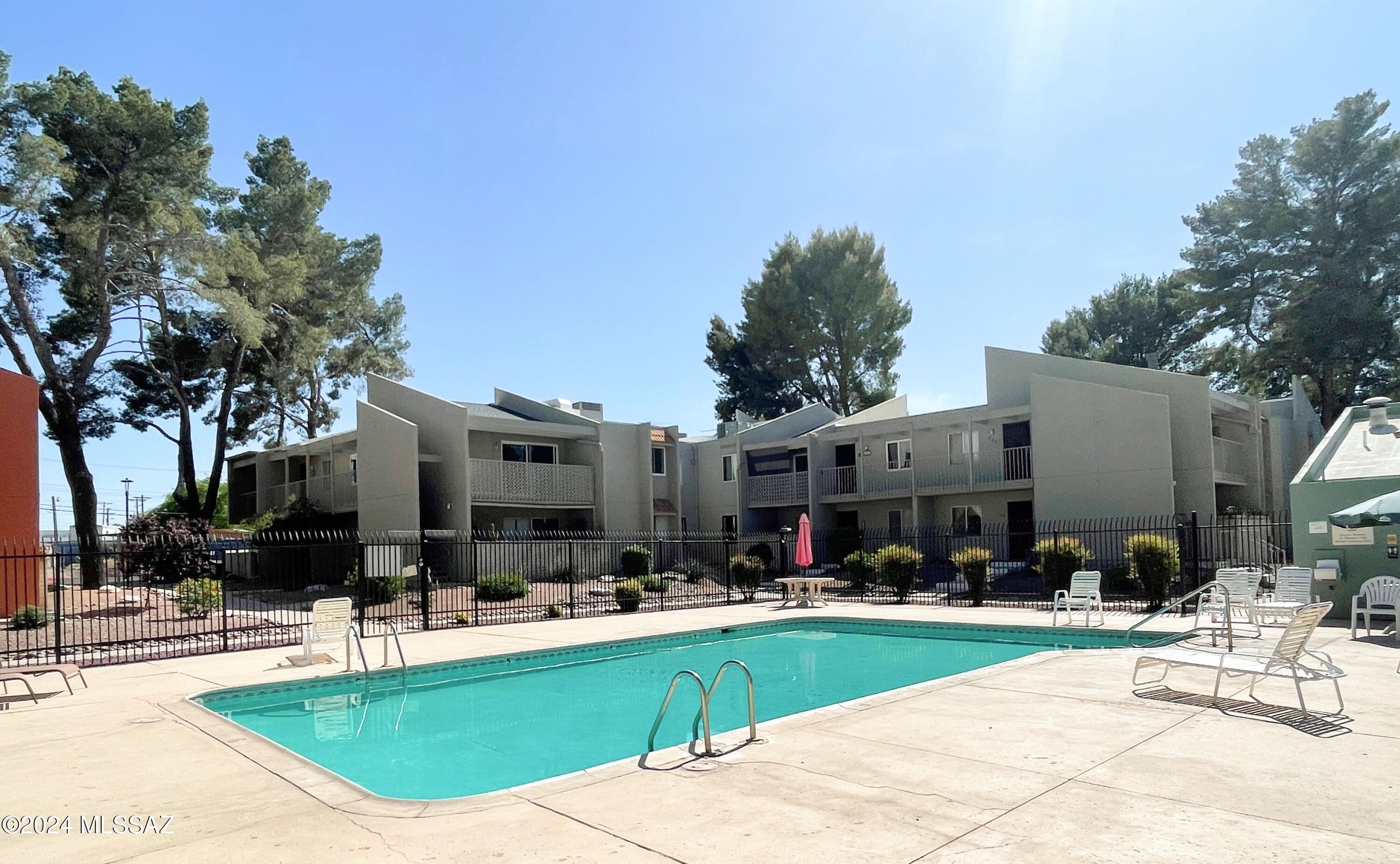 No Application Fees!  Second floor one bedroom condo located in the Tucson community of Langley Gardens Condominiums. This home includes high vaulted ceilings, lots of second floor natural light, private balcony, neutral paint throughout and a corner unit. Large open living room with balcony access and separate dining area. Efficiency kitchen includes gas range, dishwasher, tile backsplash and refrigerator. Larger bedroom has a attached walk-in closet. One car covered parking included adjacent to the unit. Community pool offers all of the fun with none of the work.