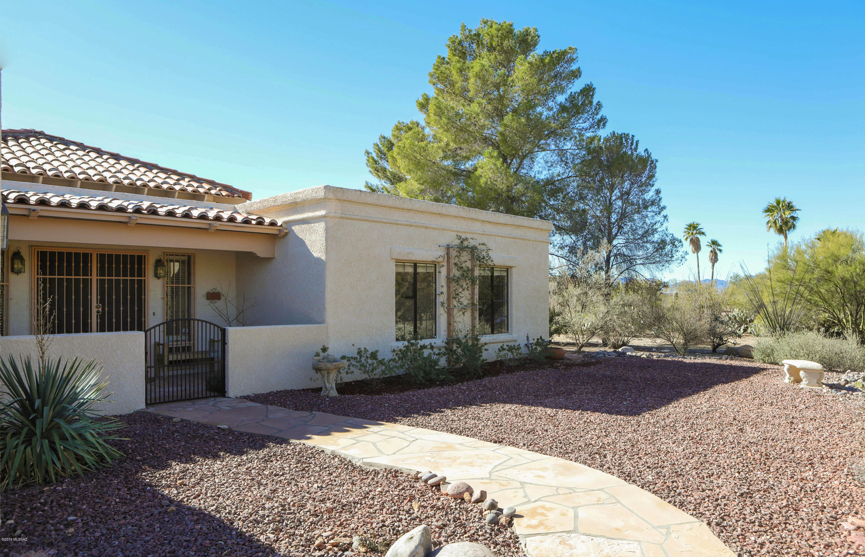 Wonderfully situated on .81 acre lot in the heart of the Foothills, this well-maintained three bedroom home in Shadow Hills welcomes you with views of the Catalina's in its own park-like setting!  Great family/entertaining home with a large Kitchen that features plenty of cabinets and counter space. Tranquil Living Room with ambient ceiling lighting and wood burning fireplace. Separate Formal Dining.  Outdoor living features sparkling pool and spa, waterfall, flower garden and swing set area in the very private backyard. 2 car garage. Catalina Foothills School District 16.