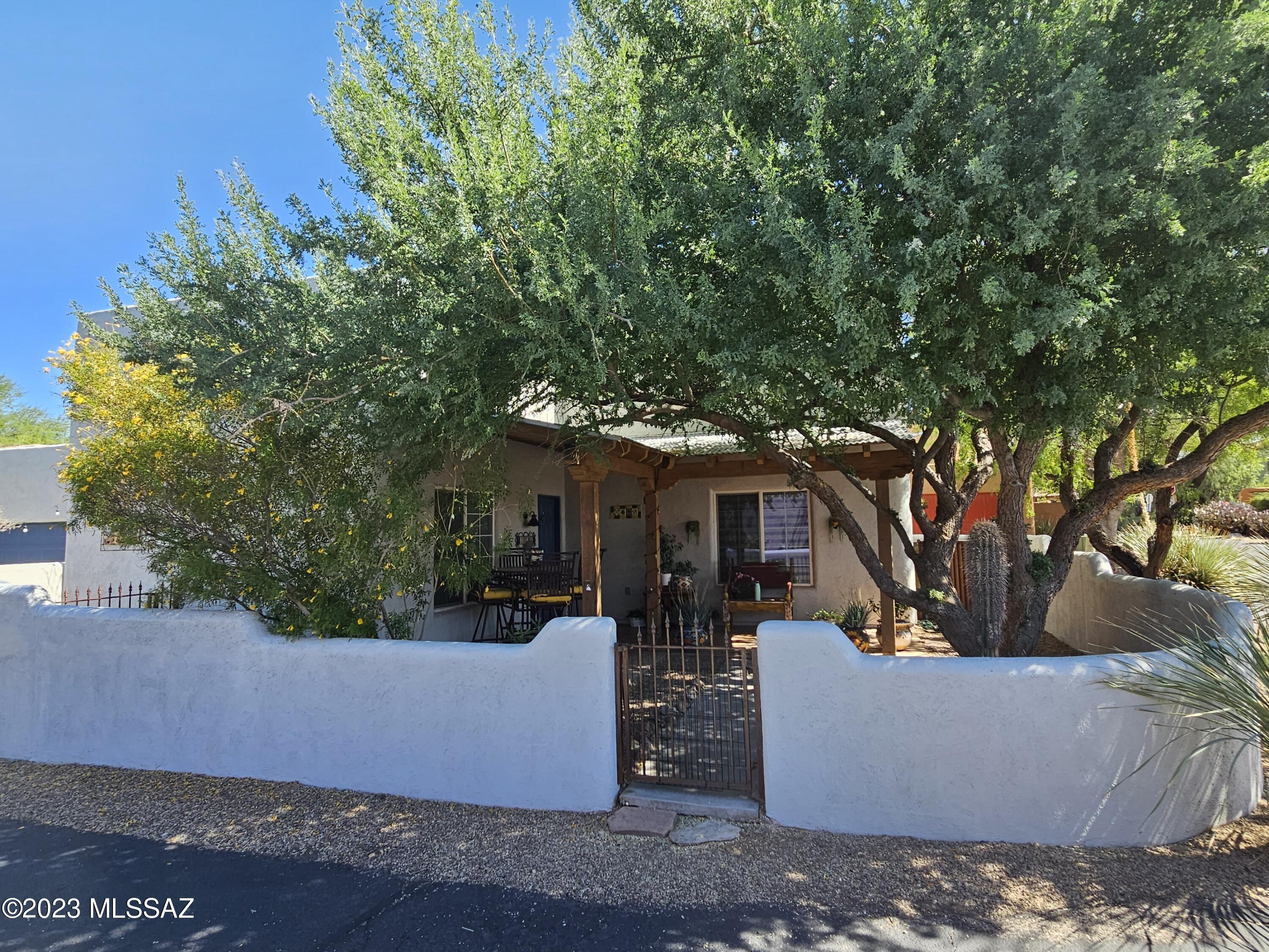 Rare Listing in quiet and unique Civano Community. Beautiful 3 bed, 2 bath Santa Fe style home. Traditionally styled throughout with Saltillo tile floors, kiva fireplace, high ceilings with exposed beams. Lovley courtyard entrance with mature landscaping. kitchen has Mexican tile counters, Gas range, built in microwave, pantry. Master bedroom on 1st floor with master bath, walk-in closet. 2nd level stairs, and bedrooms, new carpet. Cozy covered flagstone patio with fire pit. Civano Community's amenities includes tennis courts, pool, and more!  All appliances included.
