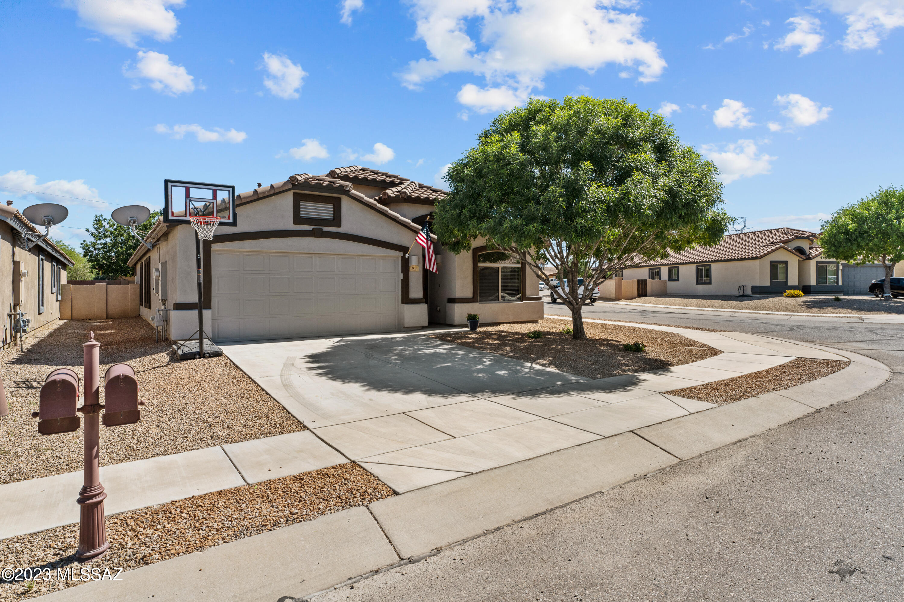 Fall in love with this adorable single story home in Rancho Sahuarita. Fresh exterior paint helps this home stand out with curb appeal on a large corner lot. Walk inside and prepare to be delighted by the beautiful custom fireplace that is the focal point of the living room. Continue throughout the house to find more fresh paint and just the right amount of shiplap to make Joanna Gaines smile. The eat in kitchen opens up to the great room making it perfect for entertaining. Elegant double doors lead you to the spacious primary suite. Three additional bedrooms means there is plenty of room for everyone. The backyard is simply gorgeous with flower beds, pavers, and natural green grass. Don't miss out on this opportunity to own this beautiful home!