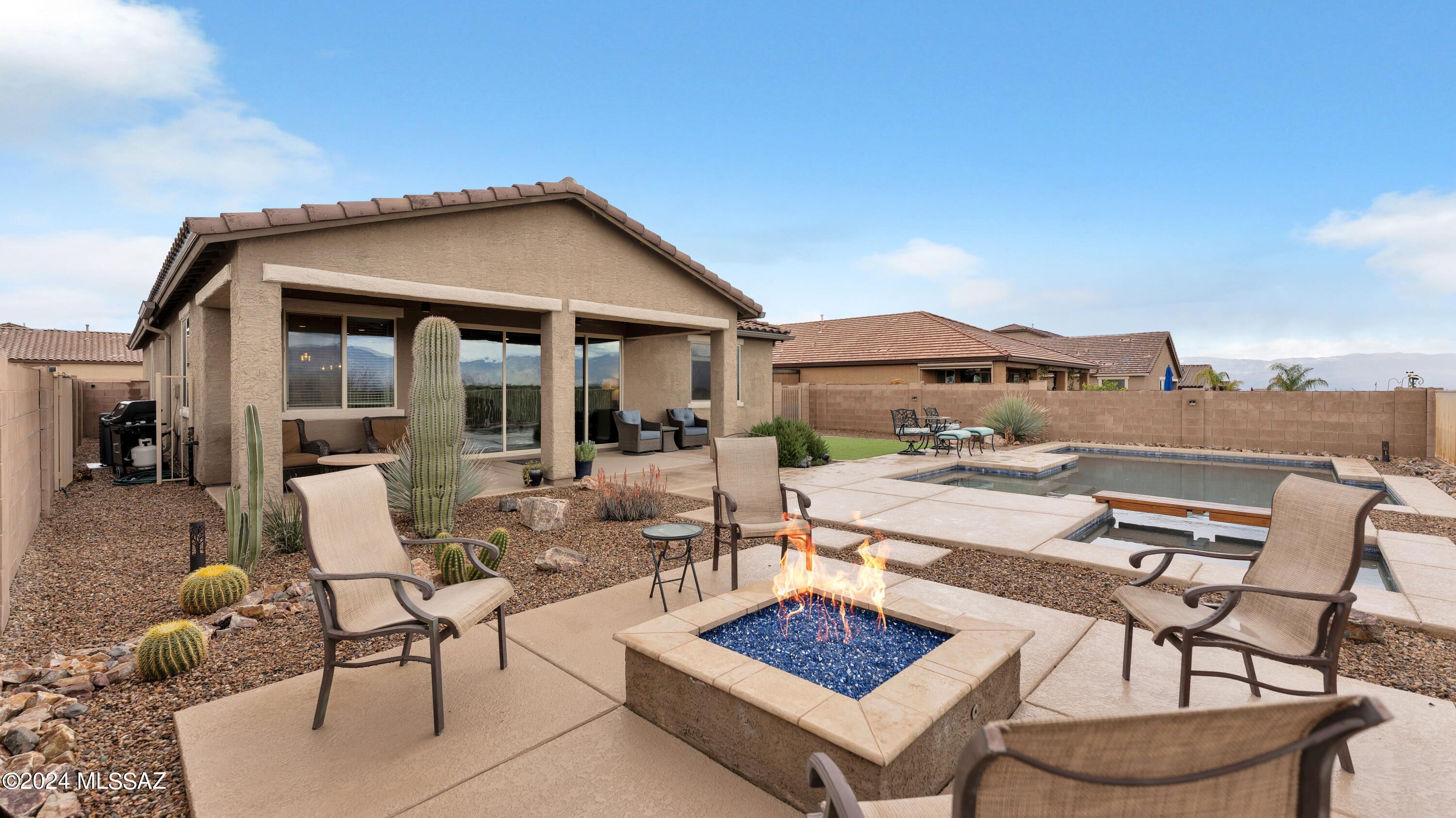 Striking three bedroom and den single-story home on a desirable lot offering unobstructed mountain VIEWS! No neighbors to the back-backs up to State land. Enjoy cooking in the beautiful kitchen that opens into the great room and dining area. The handsome kitchen features dark wood cabinets complimented by luxurious granite counters, subway-tile backsplash and SS appliances. Spacious sit-up island with Farmhouse-style sink, lovely pendant lighting, pantry, double ovens and a 5 burner gas cooktop check all the boxes for a gourmet kitchen. The great room/dining and kitchen area are light and bright featuring large windows and oversized sliders focusing on the beautiful backyard and views beyond. Public areas feature wood-look plank tile; interior doors are 8'. Split primary bedroom suite offers lots of light from big windows with the same backyard views. In addition to the two secondary bedrooms, the home includes a "bonus" room-could become a bedroom, office, den or exercise room but today is enjoyed as a hobby room. Keep cool with ceiling fans in the great room, all bedrooms and the bonus room. Enjoy the private backyard retreat featuring an extended covered patio-with overhead fans, recessed can lighting, lush artificial turn, built-in gas fire pit, wrought iron view fencing, sparkling heated pool & spa (with colorful moodl ighting), hardspace pathways and landscape rock with an abundance of natural desert and unobstructed VIEW (picturesque Rincon and Santa Rita mountains, brilliant sunrises, and reflecting sunsets)! The roomy 3-car garage features overhead racks, water softener and an epoxy floor. The 50-gallon Hydro Jet Performance hot water heater provides less sediment while producing more hot water. This home, nestled in the wonderful community of Mountain Vail Estates is located in the Vail School district and provides easy access to I-10, U of A Tech Park, DM Air Force Base and less than a 30 minute drive to Raytheon. Enjoy nearby shopping, medical services and entertainment as well as neighborhood pocket parks, close proximity to Esmond Station K-8 School and Library, Regional Park with exercise stations, trails, and picnic ramada.