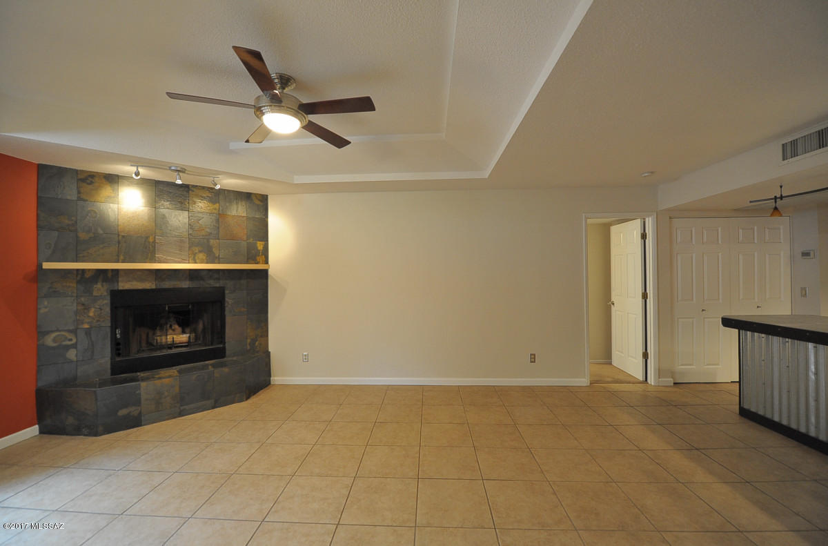 Downstairs condo. A must see!  Lots of upgrades and beautiful! All ceramic tile with carpet in both bedrooms. Kitchen has been fully remodeled and opens up into the living room with wood burning fireplace. Large master with two closets. Master bath has dual sinks with a step in shower. Guest bath has dual sinks with a tub/shower combo. Washer/dryer included. Community pool and spa, exercise room, club house and gate that leads to the Rillito River Walk. Ask about P#2960-R