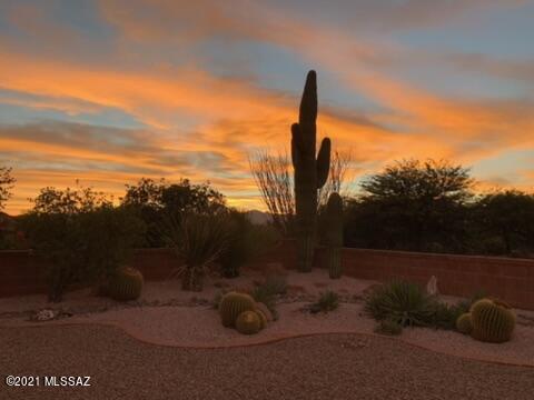 Mountain Views, large lot, no rear neighbors, and conveniently located in Las Campanas. A large, fenced, front courtyard leads you into this colorful home where you can immerse yourself in southwestern style. Vaulted ceilings, tile flooring except in bedrooms. Enjoy your view from the master, family room, and kitchen with pull out shelving, gas range, and tile countertops. The master has access to the rear patio, vaulted ceiling, and large walk-in closet. Your guests have their own privacy with a pocket door separating the guest bedroom and bath from the rest of the home.  New laminate flooring in the den/craft room. Step out back to the covered rear patio with ramada, pavers, fruit trees to find your own sanctuary to enjoy the sunrise and sunsets. New Trane HVAC 2015 with warranty.
