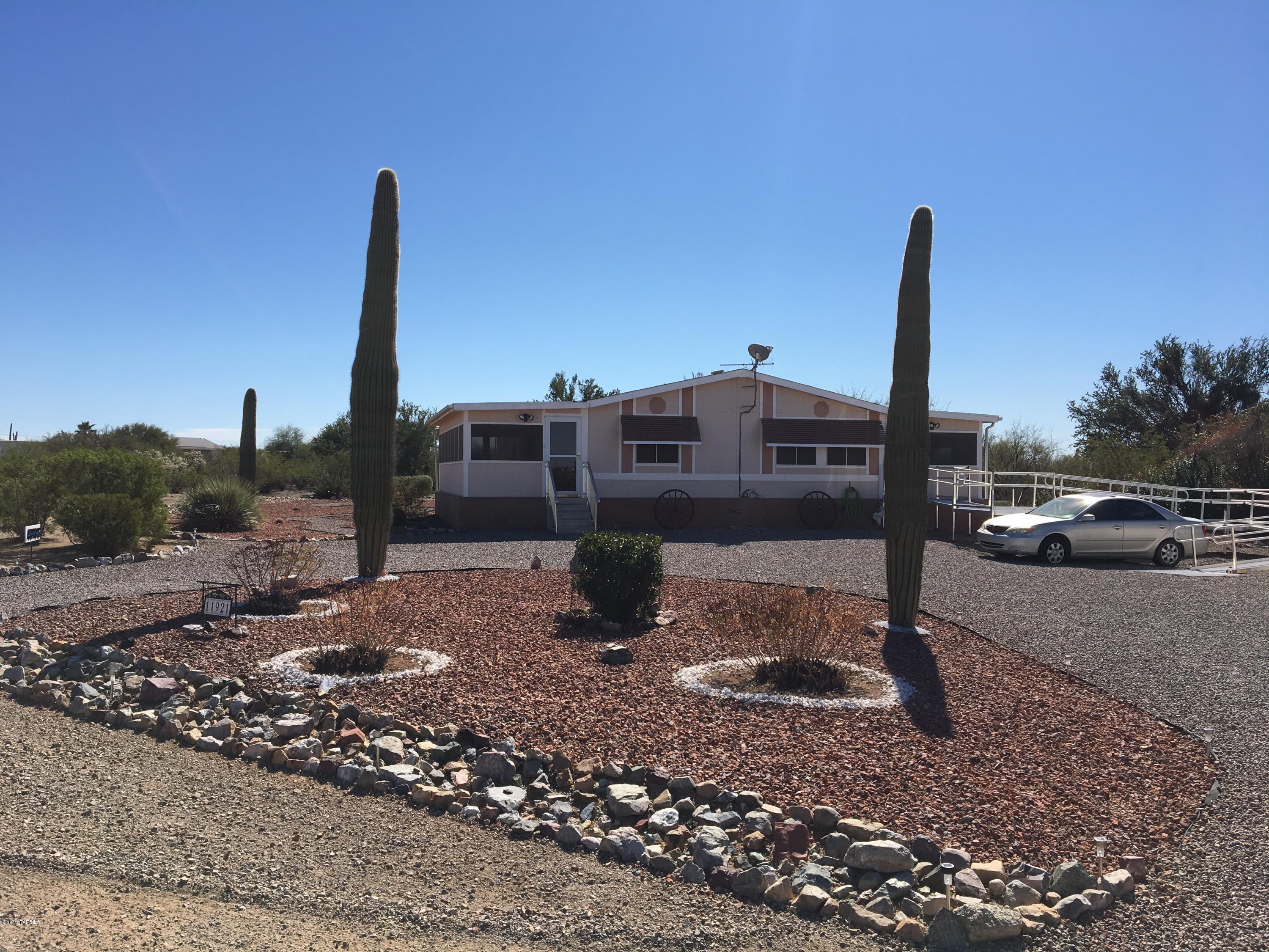 Spacious home in a beautiful neighborhood. Screened in porches on the front and back of home for amazing views. Landscaped front and backyards with solar lighting and decorative rock. Large two car garage with workshop room inside. Vacant acre to the east, makes this one acre feel like two! Give this one a look!