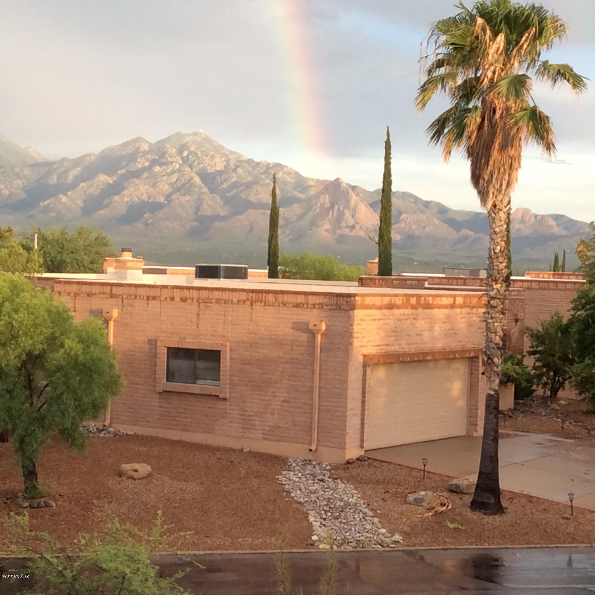 VIEWS, PRIVACY, UPDATED --Upgraded custom Barcelona model features enlarged kitchen w/ higher end stainless steel appliances & granite counter tops w/ substantial bull-nose edging. Natural stone - travertine floors lead to bright dining area open to living room facing the magnificent Santa Ritas & Santa Cruz Valley.  Spacious rooms w/ large windows & great views on all sides of this free standing home on a very large lot (almost 1/2 acre).  Well placed beehive FP in living room, Elegant travertine & glass block walk-in master shower, New coated garage floor, are representative of countless added touches.  Agent owned property. No neighbors directly in front or behind. Enjoy sunrises, sunsets, moon rises, stars, changing mountain hues, .... cardinals, quails and all wonderful desert sounds from this great home. Back of property borders the new county park with wonderful walking trails