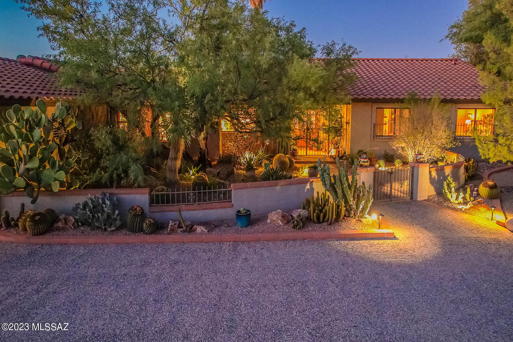 Lovely custom home for sale in the highly sought-after gated community of Powder Horn Ranch.  This stunning one level story home has 4 bedrooms, 2 ½ bathrooms with striking Mexican tiled floors throughout.  Exposed adobe brick walls and soaring wood beams ceilings greet you upon entry with natural light filtering in the from the north-facing picture windows with views out to the private, resort-style backyard.  The kitchen has a custom-built Mesquite island countertop with a new electric induction cooktop.  The primary bedroom and the TV den both have custom-built-in bookshelves with storage cabinets.   The home has a separate dining room, living room with fireplace, screened-in Arizona room, outdoor BBQ area has built-in grill, wood-fired pizza oven and a wood-burning fireplace - - all this complements the extraordinary outdoor living and pool areas.  Included with this well-maintained home are NEW HVAC units (2), hot water tanks (2), tiled roof, 200-amp electrical service and the garage/storage area is heated and cooled.