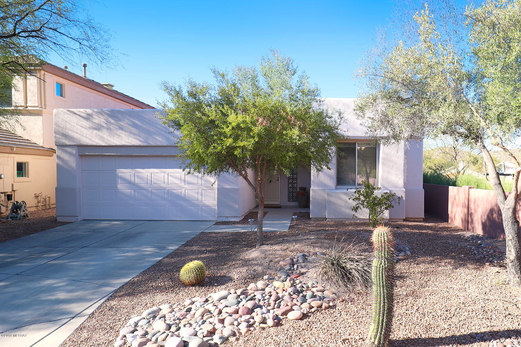 Glorious mountain views abound from this special home securely sited on a cul-de-sac street in a gated community within walking distance to schools, walking trails, etc. High ceilings w/multiple skylights and walls of windows & glass doors provide optimum light & views. Neutral, oversized floor tiles are found throughout most of the home. The kitchen features gas cooking, all new appliances, a wrap-around breakfast bar + additional eating area & pantry.  A spacious master suite with a garden tub, separate shower and large organized, walk-in closet. Additional den/office/4th bedroom or ???. The rear yard is buffered for quiet & privacy by a large lushly vegetated arroyo to be enjoyed from the large, covered patio or flagstone walkways and additional seating/entertaining area.