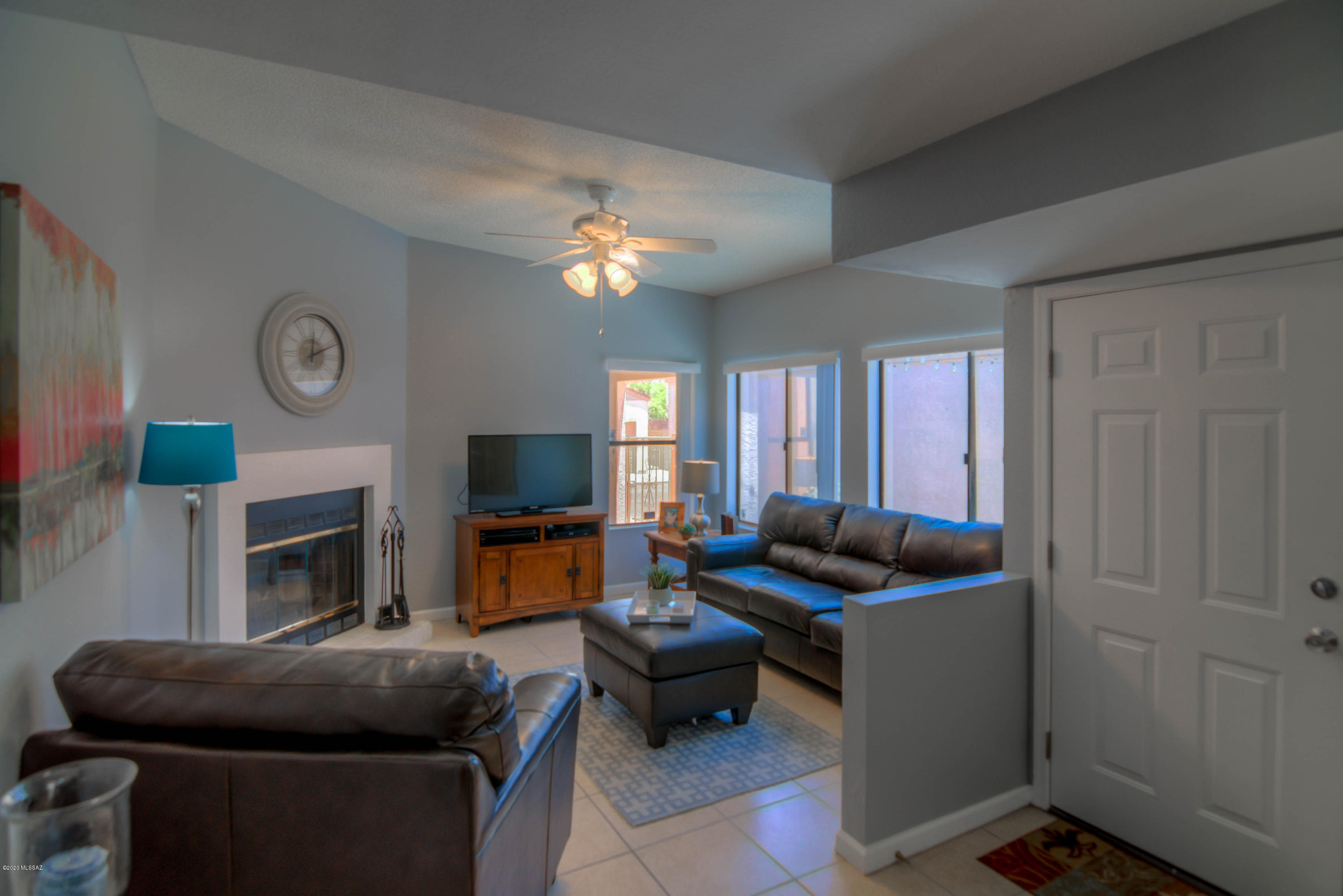 Discover this elegant townhome in the highly coveted Casitas De Palo Santo neighborhood.  This charming home features three bedrooms (Primary Bedroom downstairs!), two bathrooms, cozy wood-burning fireplace, washer/dryer, two car garage, storage and a private courtyard.  The beautifully appointed interior finishes include modern interior paint and light fixtures, engineered wood and ceramic tile flooring, engineered stone kitchen counter tops, stainless steel appliances including the refrigerator and updated bathroom vanities.   This wonderful gated community features mature landscape and a community pool/spa.   Be sure to ''walk'' through this lovely home with our 3D tour found under the Photos tab.   You won't want to miss this opportunity, schedule your private tour today!