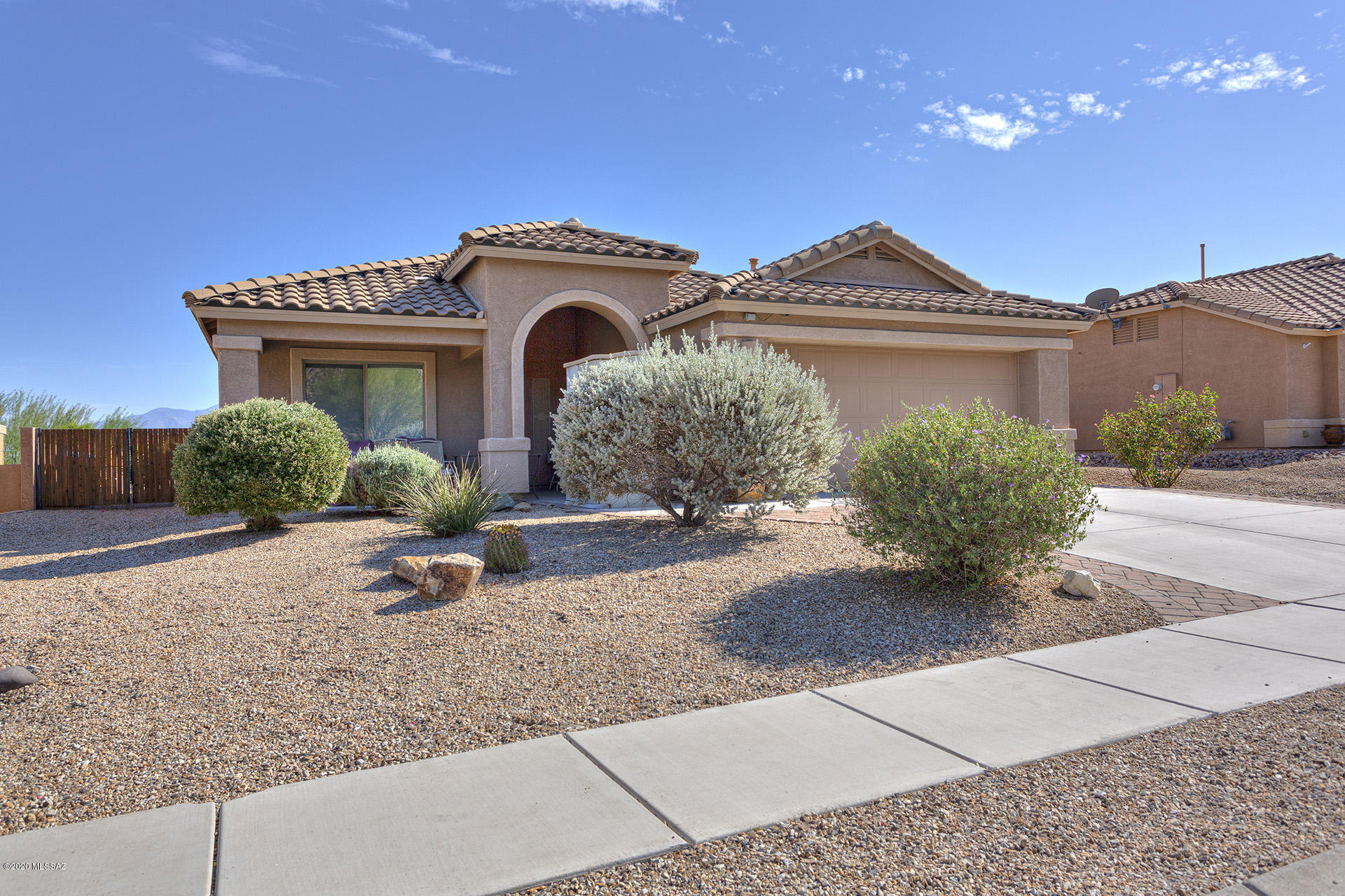 WECOMING, WARM & CHARMING; THIS HOME IS OUTSTANDING. VIEWS ARE AMAZING & MAY BE ENJOYED ON YOUR COVERED PATIO W/ OR WITHOUT CUSTOM SOLAR SHADES. ENTRY TO HOME BRINGS YOU INTO THE FOYER & INTO THE OPEN CONCEPT.  KITCHEN IS EASY TO WORK, PLENTY OF STORAGE, PANTRY CLOSET & A KITCHEN ISLAND. DINE IN KITCHEN NOOK W/VIEWS & BEAUTIFUL LIGHT. SLIDER OFF THE NOOK; MORNING COFFEE IN OR OUTSIDE. ALL APPLIANCES INCLUDED; BRIGHT WINDOW ABOVE SINK. GREAT ROOM IS FRAMED W/GORGEOUS BACKYARD & MOUNTAIN VIEWS. GAZE OUT TO  MANICURED LANDSCAPE; TRICKLING WATER FOUNTAIN, MT VIEWS & ELEVATED PATIO; CUSTOM DREAM BACKYARD. MAIN SUITE IS SPACIOUS W/ENSUITE & WALK IN CLOSET. 2ND BDRM/OFFICE & HALLWAY BATH ARE SPLIT BEDROOM PLAN. LAUDRY HAS STORAGE W/D INCLUDED. GARAGE W/WORK BENCH & EPOXY FLOORS. *THIS IS THE ONE*