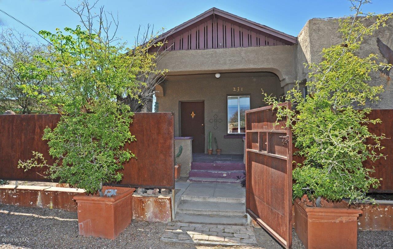 This is a Compound of 3 adobe houses. Custom metal fencing creates a private oasis where all 3 homes open onto the interior courtyard. The main house is a 2bdrm/1bth, 1195 sq. ft., built in 1932 and has AC. The northern adobe is a 1bdrm/1bth, 576 sq. ft.,  built in 1920. The southern house is a 2bdrm/1bth, 862 sq. ft.,  built in 1925. The vacant lot to the south, 117-03-205B can be purchased as a package. Dunbar Springs is a wonderful Downtown community and there is great potential. This is an estate sale so please give time for response.