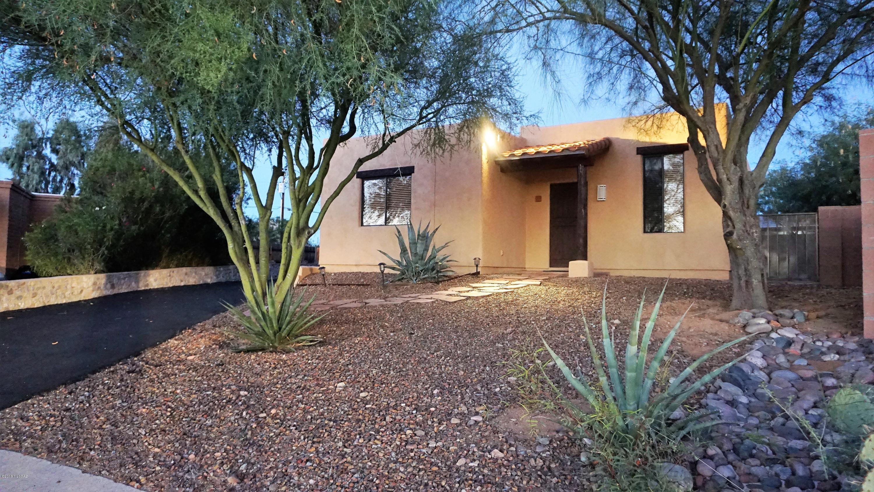 Custom Santa Fe! Bring the RV! HVAC & gas range less than a year old. Desirable quiet area with dark night skies,  no HOA, excellent schools. Authentic colored concrete flooring, Viga accents, & rustic Wrought Iron Security doors & gates throughout. Many special features - newer bathroom vanities, concrete privacy walls, solar lighting front & back.  Drive through double gates from carport & rear of property to bring in your toys or install a pool! You'll never leave the .20 acre yard with raised paver patio just perfect for entertaining. Horshoe pit, Roomy Storage Shed and Covered Patio. It's easy to fall in love with the privacy between neighbors, sweet cul de sac loacation, mature trees, & graceful flagstone walkways.