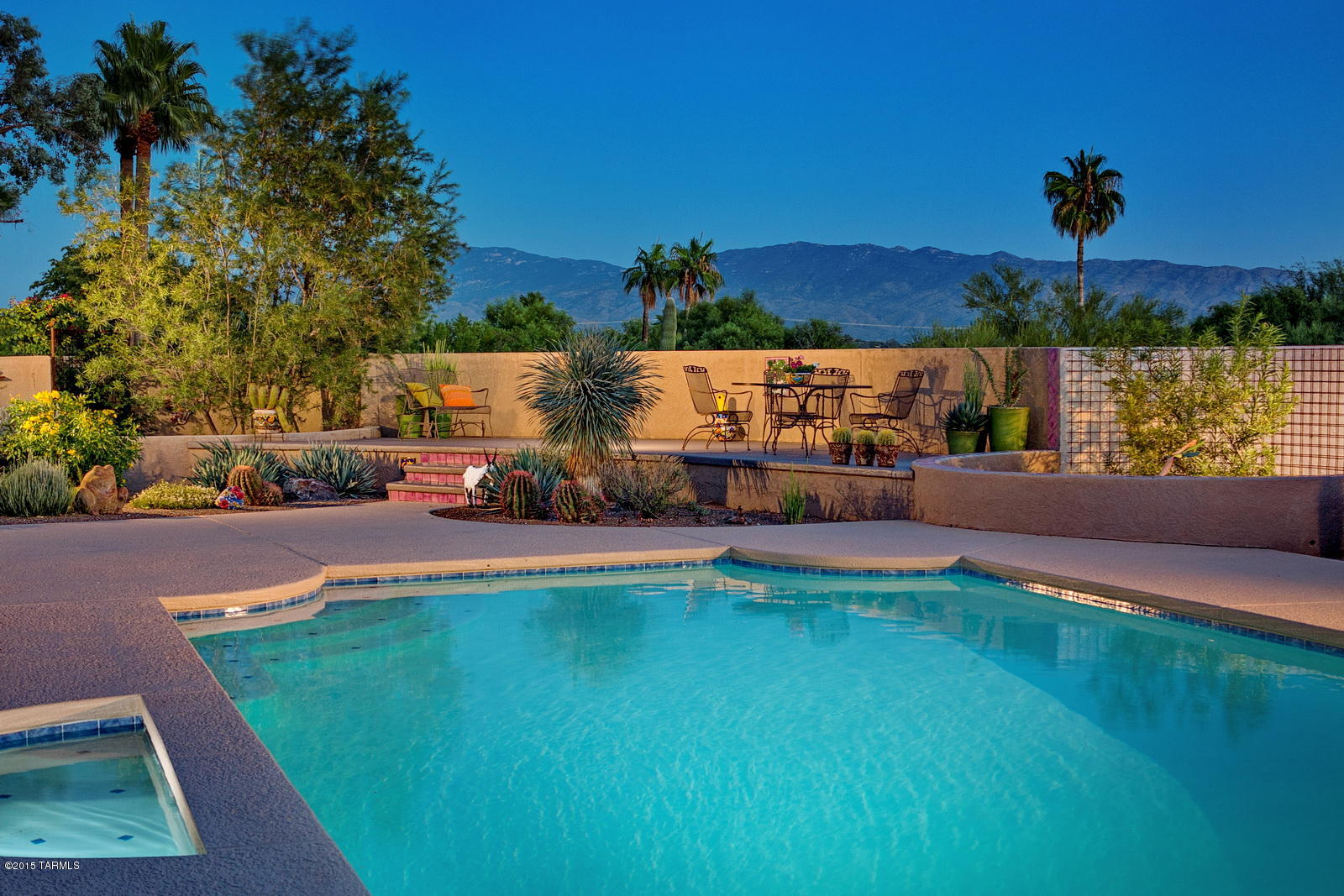 SIMPLY SUBLIME!  Distinctive Masonry Construction by Andrew Arena, sited on Private, Mountain View lot and wrapped in Colorful Desert Gardens designed by Professional Landscape Artist, Scott Calhoun.  Richly Authentic Architectural Elements: High Beamed Ceilings & Big Picture Windows, Concrete Floors & Sprawling Patios create a kind of ''Laid-back Luxury'' that speaks to the Heart of Family-living and Entertaining.  Updates include a Sleek, Modern Kitchen in alder wood, granite and stainless steel, with unique tile accents.     Versatile Floor Plan with spacious Sunlit Rooms.  Master Suite w/gas Fireplace.  Separate entry for Guest Wing.  Fabulous HOA Amenities!  Prime Location, Close to Canyon Ranch, Tucson Country Club, Sabino Canyon, Lowe's Ventana Canyon Resort, Restaurants & Shopping.