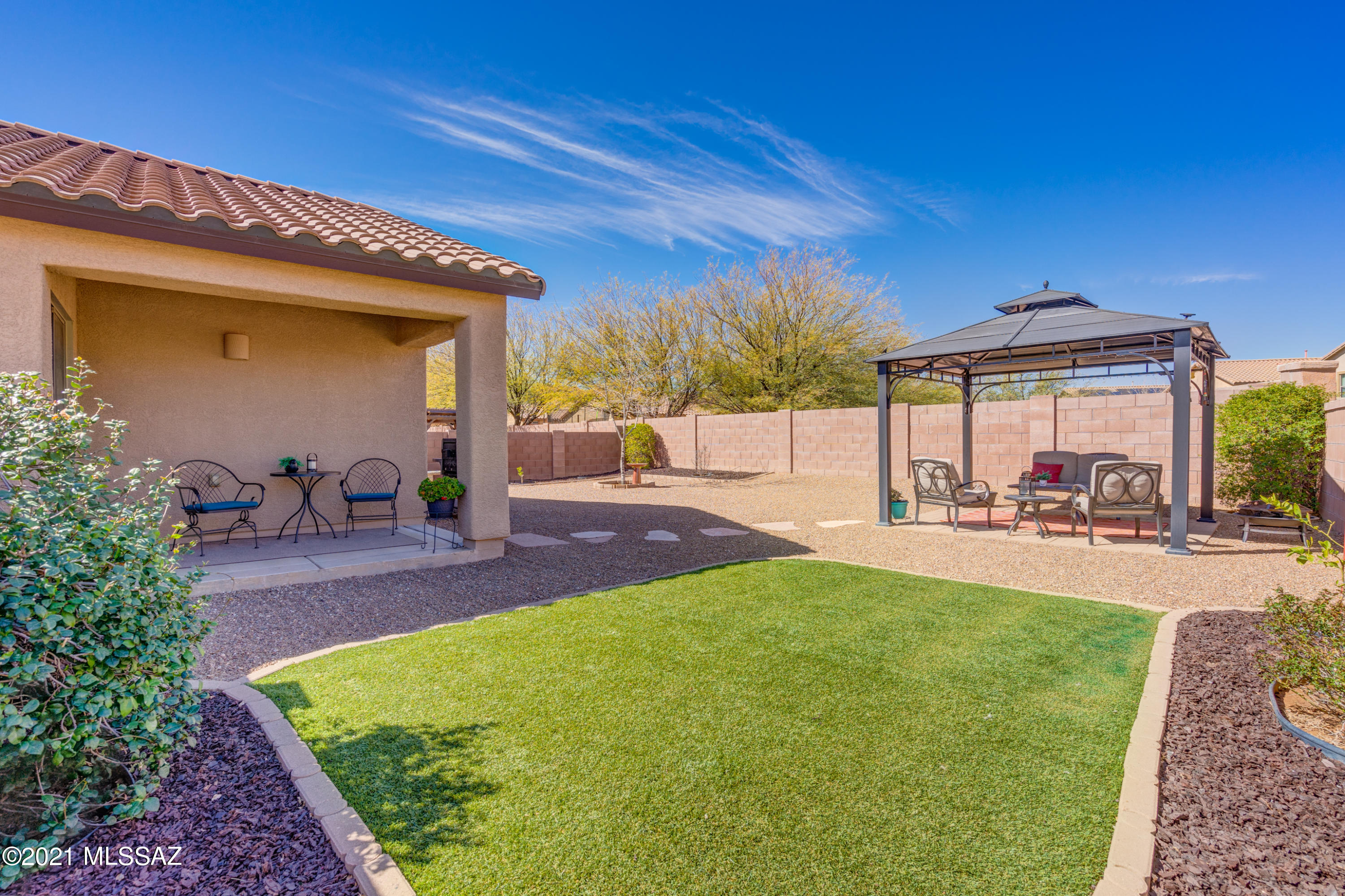 HUGE private lot in Rancho Sahuarita. Great home on a large pool-sized lot. Like NEW 3 bedroom, 2 bath with a den/home office, DR HORTON built home with many upgrades. Features a open GREAT ROOM floor plan, granite counters with breakfast bar island, upgraded cabinets, & stainless appliances. Upgraded carpet and tile. Remodeled master suite features shiplap wall and barn door. Upgraded lights/fans. Fresh decorator paint. Gorgeous backyard w/Gazebo, lawn area, and plenty of room for all your plans. Immaculate and move-in ready. Close to North pool park with pool, spa, play equipment, volleyball and basketball. Don't miss out on this one!