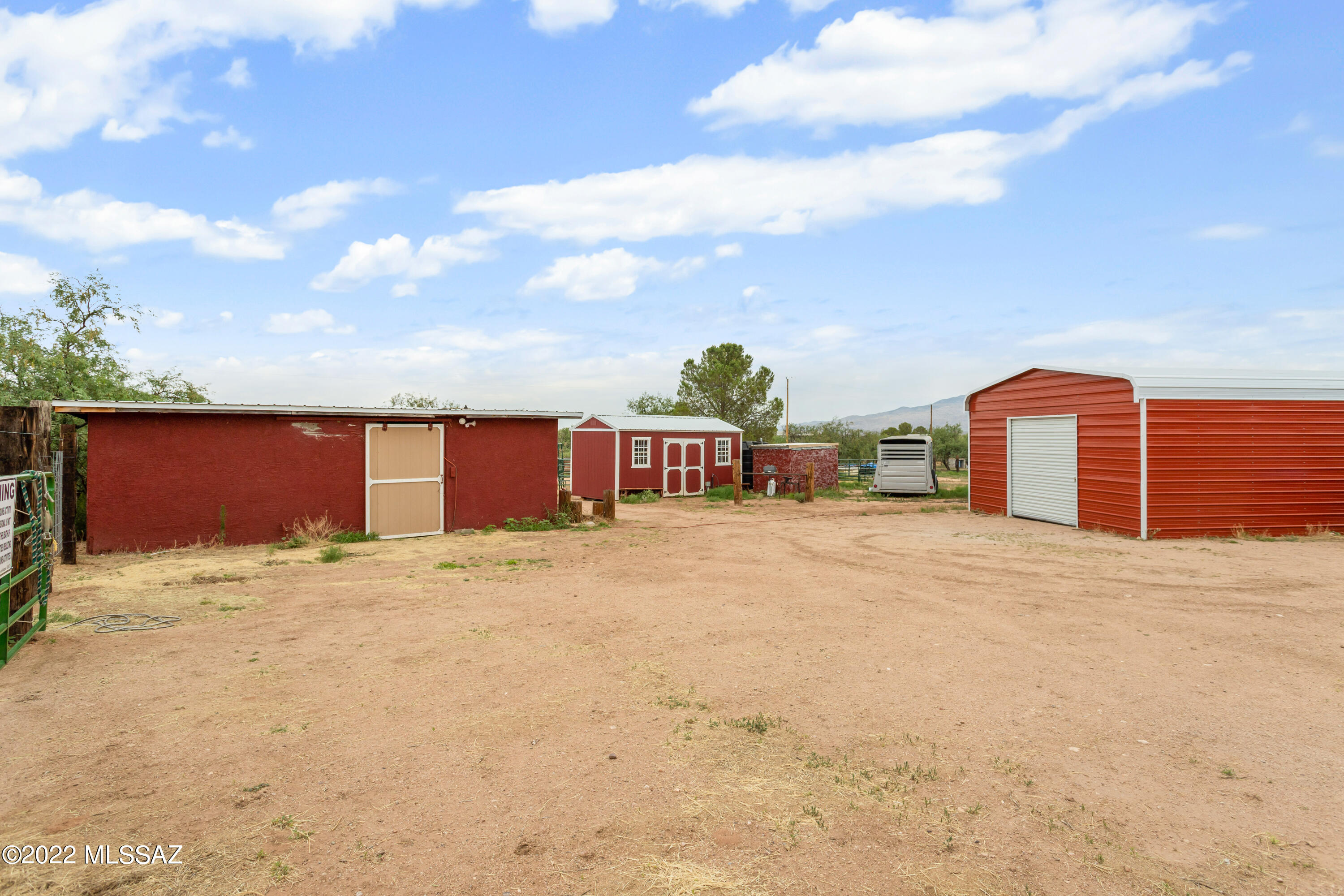 Seller will carry with $100K down. Motivated! 6.55 acres! Horse property eligible for Commercial/residential. Very unique property in  J6 Ranch. 4 parcels of land currently set up for horses immediately. 2 storage barns, hay barn, garage and a new metal barn. Older manufactured home on the property currently utilized as a residence. Owners were going to create a horse hotel or storage facility. Owned private well with a 1500 gallon storage tank. A home could be placed on each of the 4 parcels, 1/4 mile from I-10. 20 mins to Tucson, minutes from Benson and wine country.