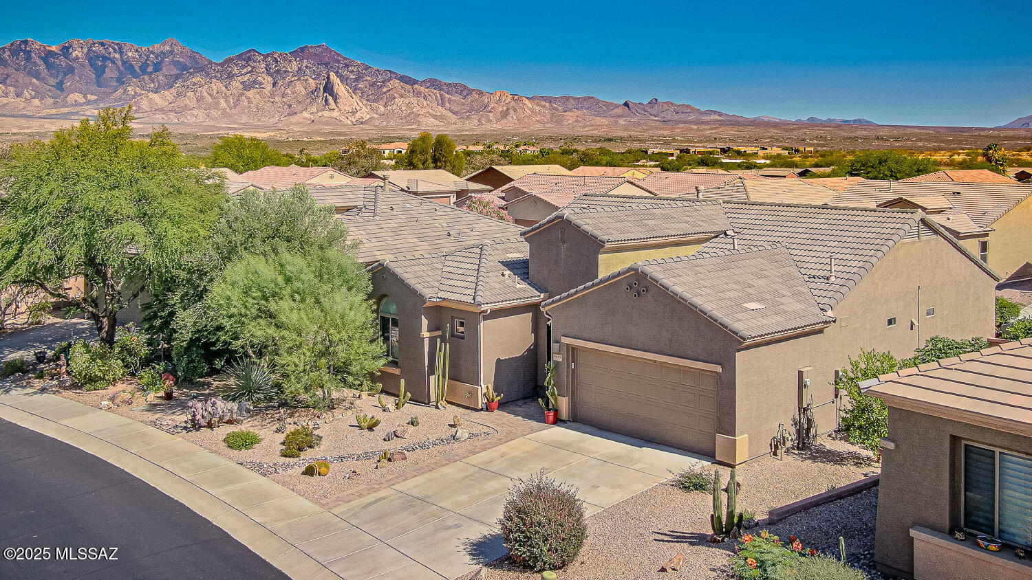 Beautiful Canoa Ranch Home, a Great Room Floorplan, 3 Bedrooms 2 Baths and a 2 Car Garage. Upgrades are throughout this home, Upgraded Kitchen - stainless steel appliances, custom tiled counter tops, back splash and upgrade cabinets with pull out shelves, slate tiled fireplace along with a decorative custom built-in unit, The 3rd bedroom has wonderful built-in desk, cabinets and bookshelves. solar on the roof. The Back Yard would be great for entertaining, citrus trees, a beautiful low care yard. Solar will be paid off prior to Closing with a full price offer.  Must See!