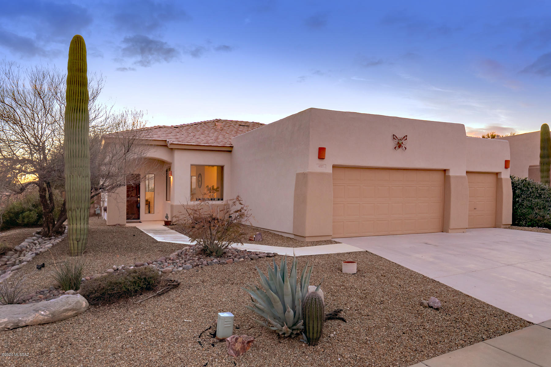 A bright and cheery 3 bedroom/two bath home on a corner lot in fabulous Dove Mountain, a planned community in the Tortolita Mountains of Northwest Tucson, is now available for discerning buyers. It's a gem, with large windows and skylights enabling wonderful natural light and views. A cozy living room with an entertainment center adjoins the breakfast bar, kitchen and sunny breakfast room. A generously sized dining room (or den as preferred) has two large windows—no claustrophobia here! Even the entry foyer has windows, with peeks of our beautiful Catalina Mountains, and is open to the living areas. The master bedroom, with room for a cozy reading area, is also well sized, with a large walk-in closet outfitted with shelving. The master bath features a glassed-in shower, separate WC and linen closet. Two additional bedrooms share another full bath. A delightful flagstone patio and covered porch overlook the garden. A three-car garage is deep and has room for a spare fridge, storage and small workshop area if desired. Handsome new fans have just been installed in the dining and living rooms. Washer/dryer in laundry room is included. All clean, spic and span and dressed up for its new owners! Please call for your private showing.