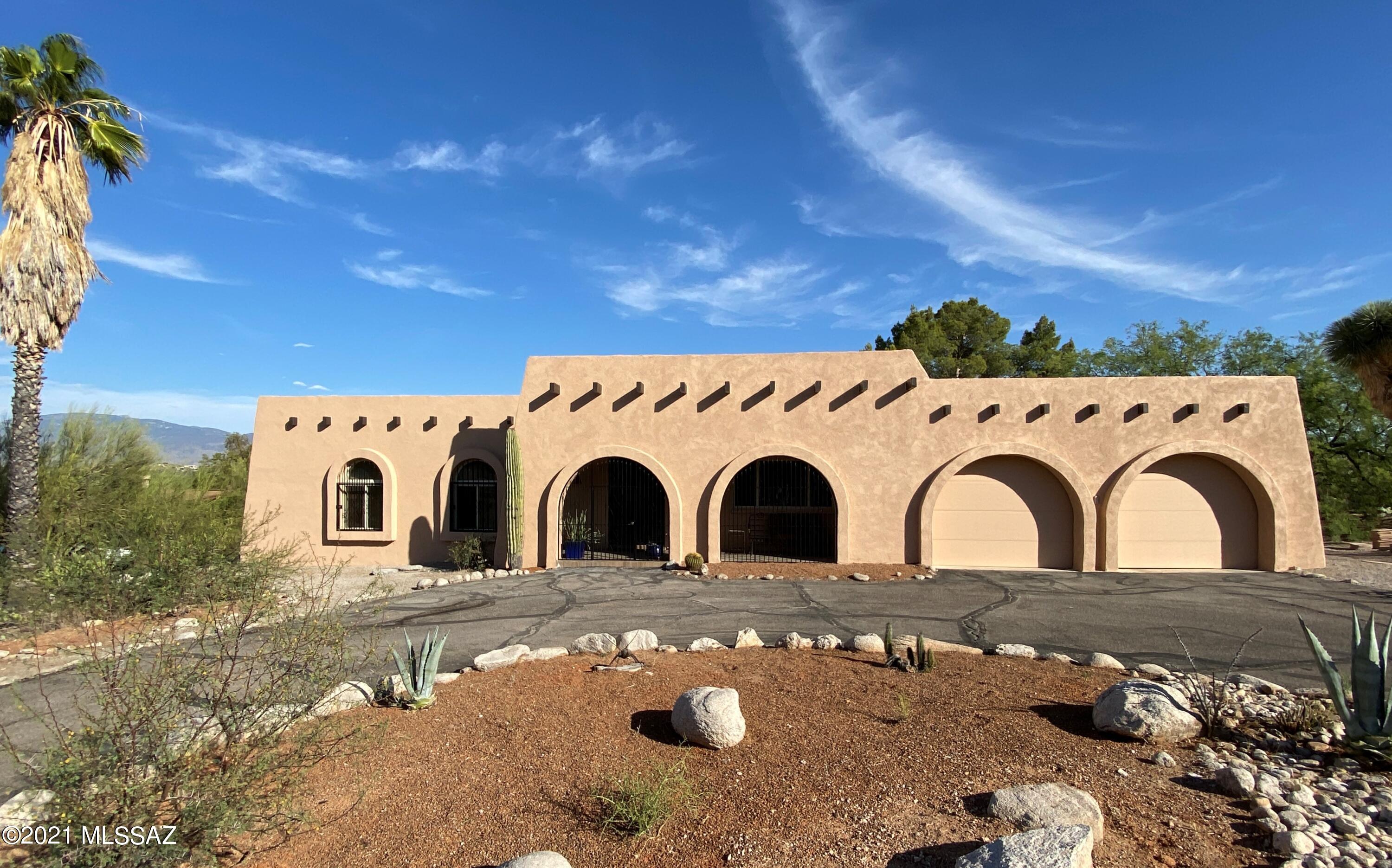 This Tourmaline Drive gem is a rare find, tucked away in the highly desirable Hidden Valley neighborhood, near Canyon Ranch and only 2 miles south of Sabino Canyon. Lovely hacienda-style decor with Saltillo and Talavera title, beehive fireplace, quartz countertops, knotty alder soft-close cabinets and a completely remodeled master bath. Energy efficient AC installed in 2018, double-pane windows and doors, and new exterior stucco and paint. Entertain friends under a covered patio or around the pool with great views of the Rincon Mountains, or enjoy your favorite beverage from the front courtyard with striking views of the Santa Catalina Mountains.