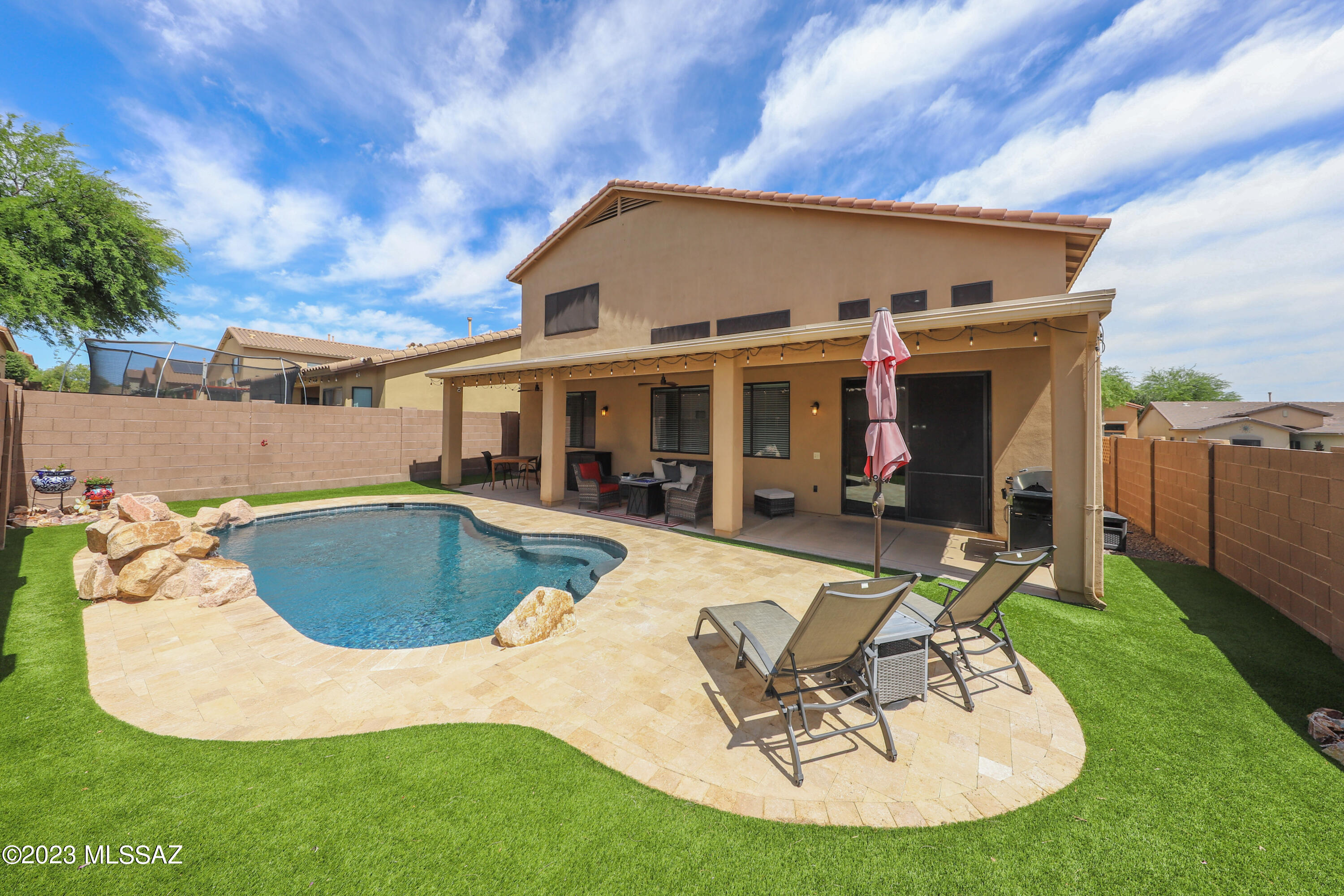 Surrounded by Pools, playgrounds, parks, green space, walking trails and all the amazing amenities Rancho Sahuarita has to offer you will find your new home nestled on a prime corner lot with a shimmering saltwater, pebble tech pool just inviting you to jump in!! Your private, backyard oasis is only the beginning of what this pristine home has to offer. A 3 car garage will greet you as manicured, mature landscaping guide the way into a light, and airy entry with stunning high ceilings for an open feel. The sizable kitchen is adorned with picturesque backyard views and lined with an abundance of cabinetry, granite counter space, breakfast nook and lovely family room. The primary suite is conveniently located on the first floor for ultimate privacy! This well appointed primary retreat has an attached, spa like en-suite complete with soaking tub, two vanity spaces, custom cabinetry and a spacious, walk in closet. On the second level you will enjoy the generous loft area, three nicely sized additional bedrooms and a charming, upgraded bathroom. Pride of ownership can be felt in all the thoughtful touches throughout this immaculate home. This home is move in ready and waiting for you to call it home today!