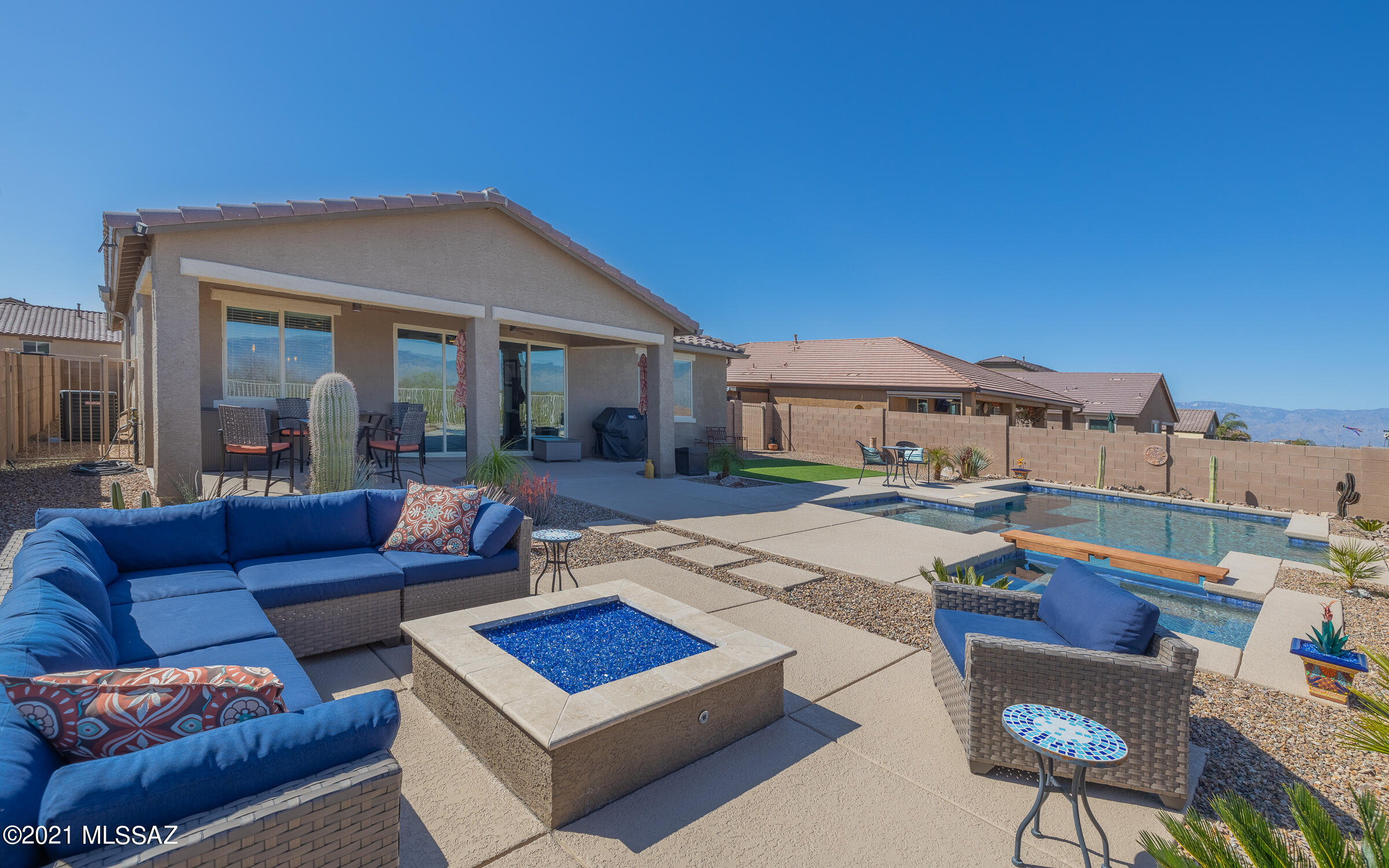 Panoramic Mountain Views on very private lot that backs to State Land. Enjoy the views from the Sparkling Pool and Spa. Enjoy the stars while you sit around the gas firepit area.   Super upgraded throughout. Gourmet kitchen offers dark wood cabinets complimented by beautiful granite counters, tiled backsplash and SS appliances. Spacious island, walk-in pantry, Double Ovens and a 5-burner gas cooktop check all the boxes for a chef's kitchen. High ceilings in the great room. Extra Large Sliding Doors to the backyard. Large Plank ceramic tile. Split master bedroom suite offers lots of light from big windows. 3 car garage with Epoxy floors and plenty of storage racks. Enjoy fully landscaped yard w/covered patio, artificial turf, built in fire pit, view fencing and extended brick patio.