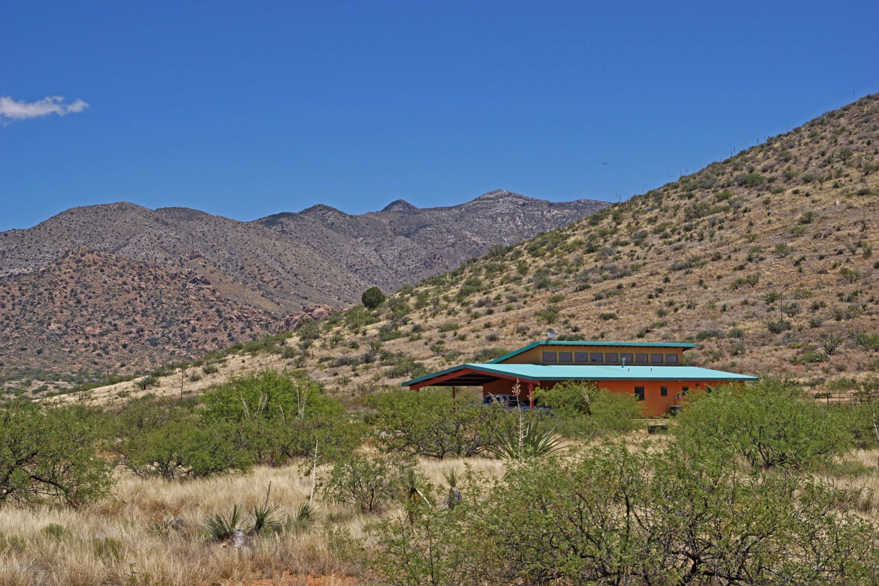 Escape the Noise of the City to This Wonderful Contemporary Home on 37 Acres of Solitude in the High Desert Grasslands of Gated Dragoon Mountain Ranch! Meticulously Constructed of Green Block Featuring Wood Ceilings Soaring to 15 Ft., Clerestory Windows, Colored Concrete Floors, Sierra Pacific Wood Framed Windows, Huge Island Kitchen and Screened in Sleeping Porch! You’ll Appreciate the Energy Savings Offered by the Passive Solar Design With R50 Walls and R42 Ceilings! Perfect for Hikers and Horse Back Riders with Easy Access to Nearby Coronado National Forest and Miles of Quiet Dirt Roads to Explore! Very Versatile Property for Full or Part Timers Seeking Breathtaking Views Where the Only Sounds Are the Songs of Birds and Breezes Blowing Through the Grass!