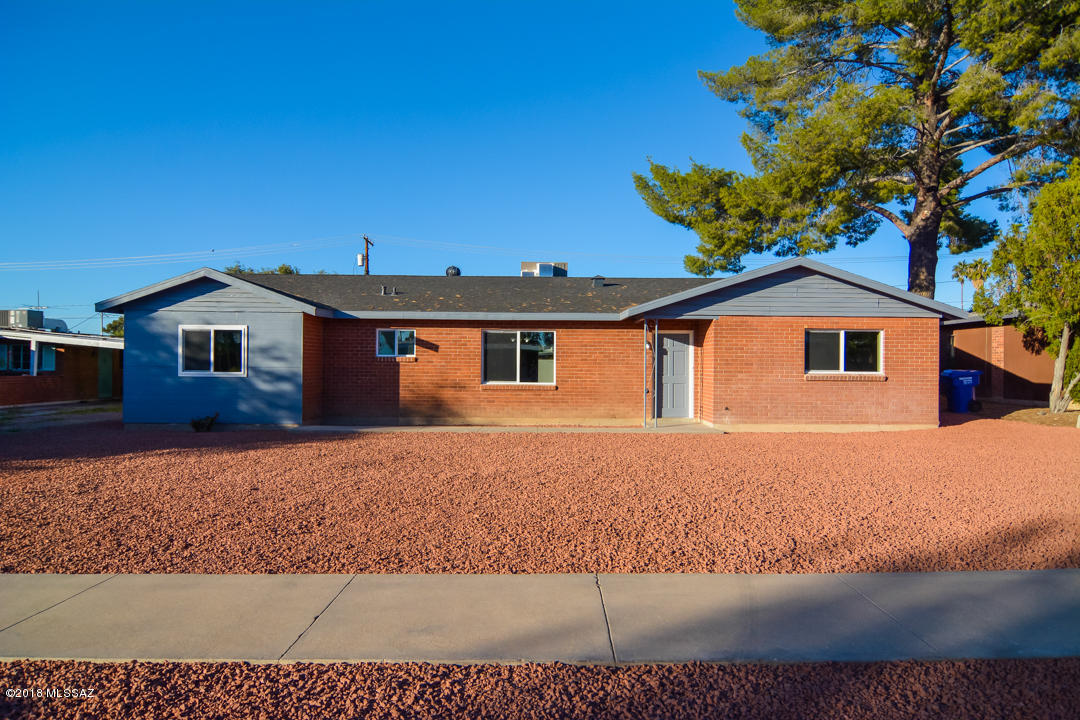 Beautifully remodeled Ranch style home. Located in a convenient Central Tucson location. Charming brick construction. Rich laminate wood flooring. New modern kitchen with granite counter tops and stainless steel appliances. New custom interior and exterior paint. New upgraded carpet in bedrooms. Large master bedroom with large walk in closet. Completely remodeled modern bathrooms. Large fenced back yard. Two car carport. Dual pane windows. Upgraded door hardware and light fixtures. This home shows beautifully.