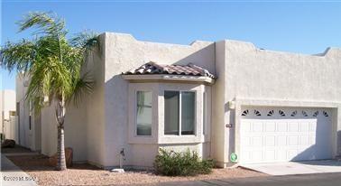 Gated adult community by the beautiful Tucson Mountains!  This split bedroom 2br/2ba floorplan offers a large open living area.  Bright light throughout.  The bay windows offer great views of the flagstone patio and provides the beautiful morning sunlight. The privacy patio includes a fireplace.  Master bath was redone in 2019.  New flooring and updated front bathroom completed in 2021.    New windows in the master bedroom and living room and a new dishwasher in 2022.  Two tall security doors. The heat pump was serviced in December 2022.  This home is completely free standing - no common wall with the neighbor!  Extra parking across the street.