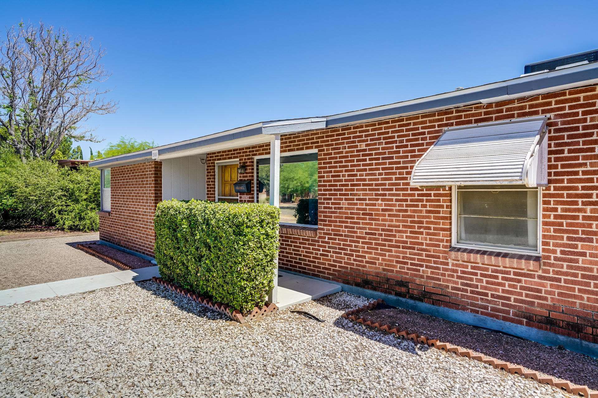 Seller will accept or counter offers between 199,995 and 210,000. Mountain Views! Great location in Casa Solariega less than 2.5 miles from U of A with easy access down Country Club.  Central 3/1 Red wire cut brick home.  Trane air conditioner new in 2014, Roof replaced 2013. Updated kitchen cabinets with soft close doors and updated counter top.  2 car covered parking out back on .24 acre lot.  Alley access.  Additional attached storage with shelving and detached storage building.  Aluminum awnings, original bathroom tile, and sweet built-ins will take you back in time! Floor plan under documents.
