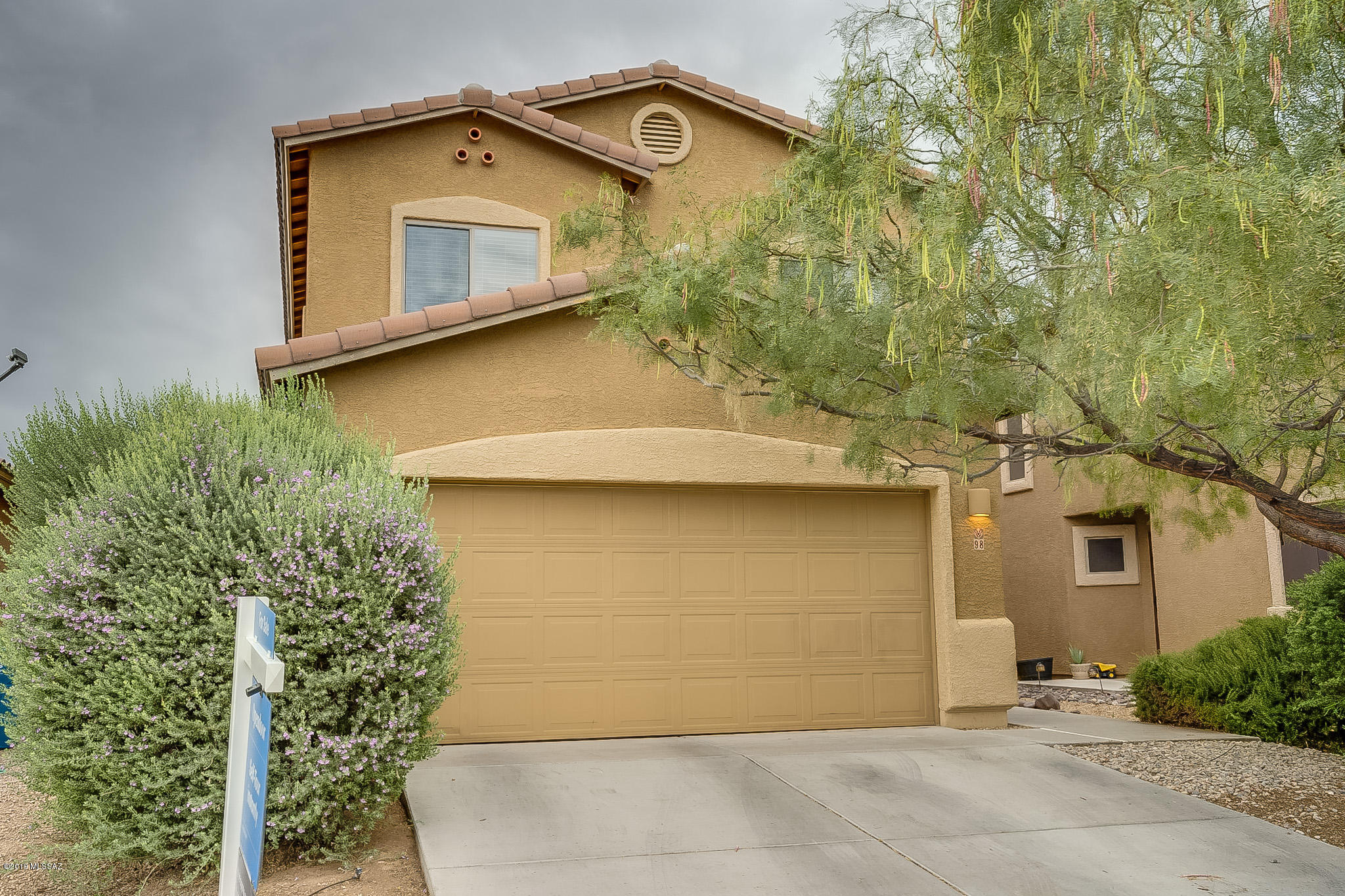 This Sahuarita two-story home offers tile flooring, a covered back patio, and a two-car garage.