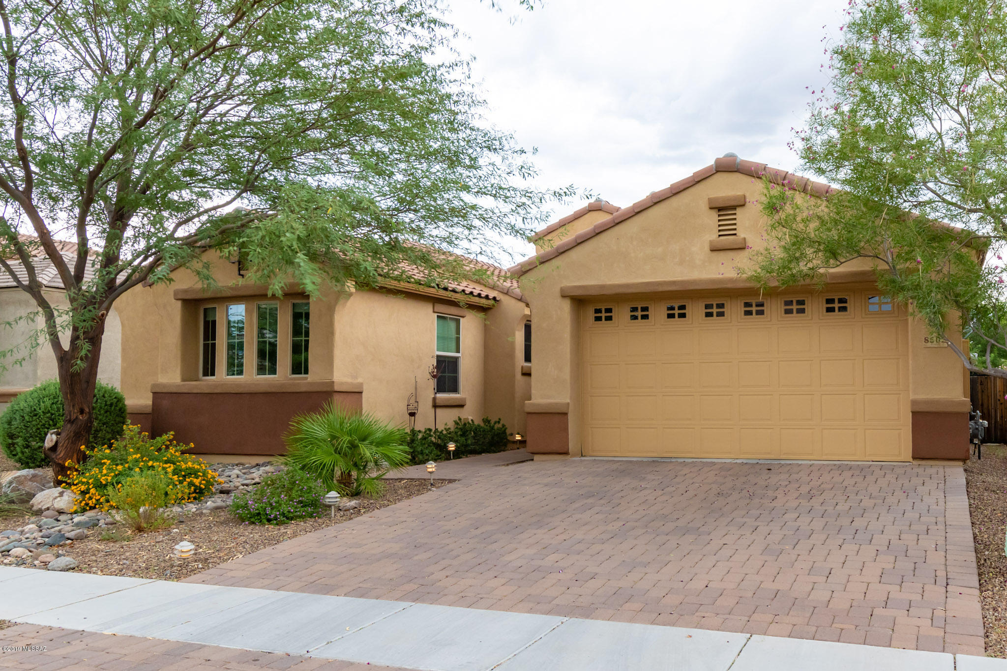 Omni Tucson National Gem!  Exceptional 2014 Contemporary home with amazing upgrades!  Offering 3BR/2BA, with Studio/Office.  Open & Bright floor plan. Great room with beautiful fireplace, Gourmet kitchen w/granite counter tops, SS appliances-includes refrigerator, lg middle island. Enjoy relaxing & entertaining in the private, charming backyard w/Mountain views.  Covered patio w/sunshades.  Solar panels leased. New washer/dryer. Omni Natl Membership available but not required.