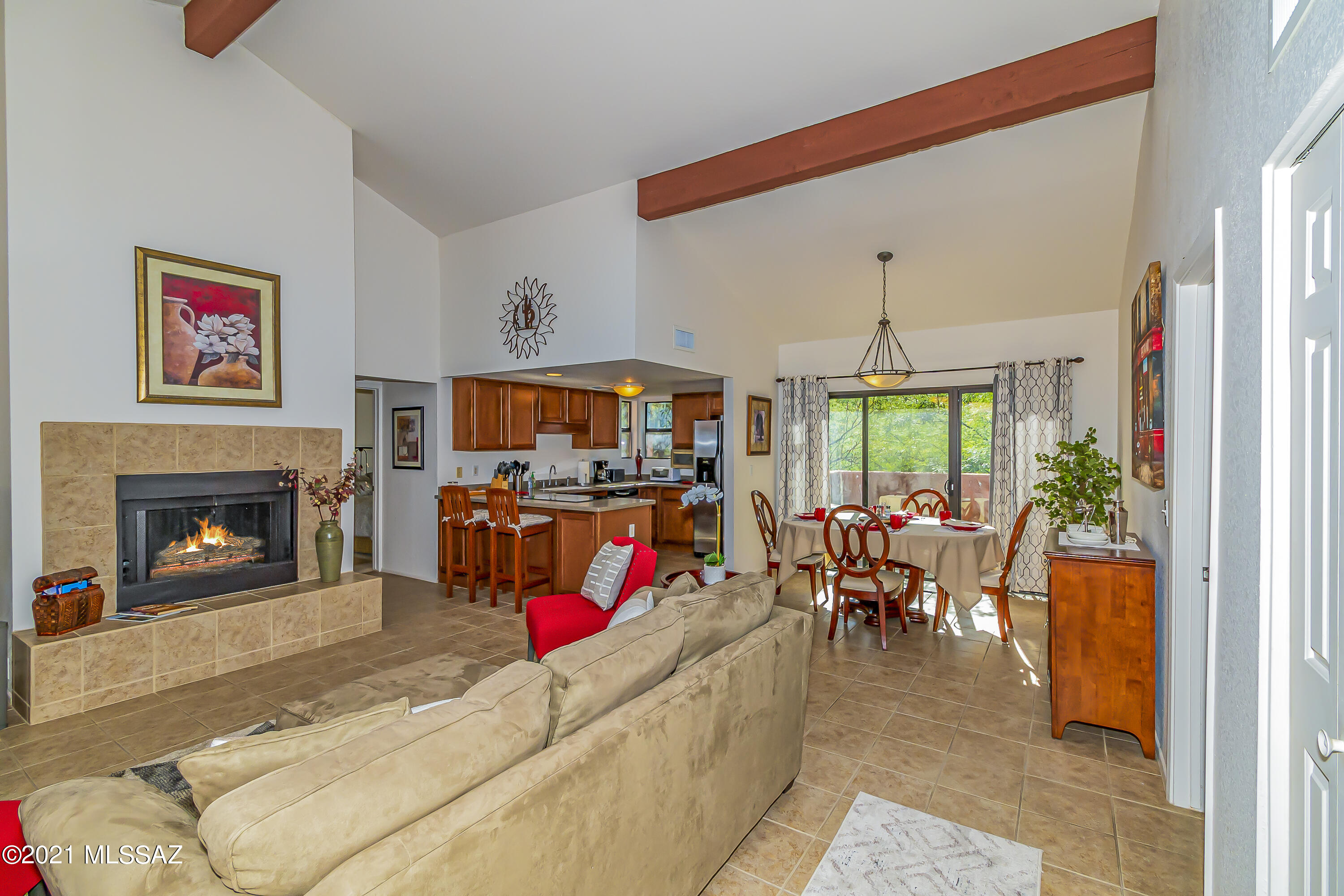 Great opportunity to purchase a fully furnished 2 bed, 2 bath condo in this sought after community. Lovingly maintained 2nd floor unit has  stainless steel kitchen appliances, Corian counters, wood burning fireplace, split bedroom plan, zoned heating and cooling, vaulted ceilings  & 3 TV's. Large primary bedroom has king size bed, walk-in closet and balcony. Guest bedroom has a queen size bed. The balcony off the dining room has an electric barbeque and overlooks a wooded area. Leased for Feb & Mar 2022  @ $2800/mo and will convey with purchase.
This gated  community has many amenities including a fitness room, recreation center, pool, spas, tennis/pickle  ball court. Located near Sabino Canyon Park, shopping and restaurants.