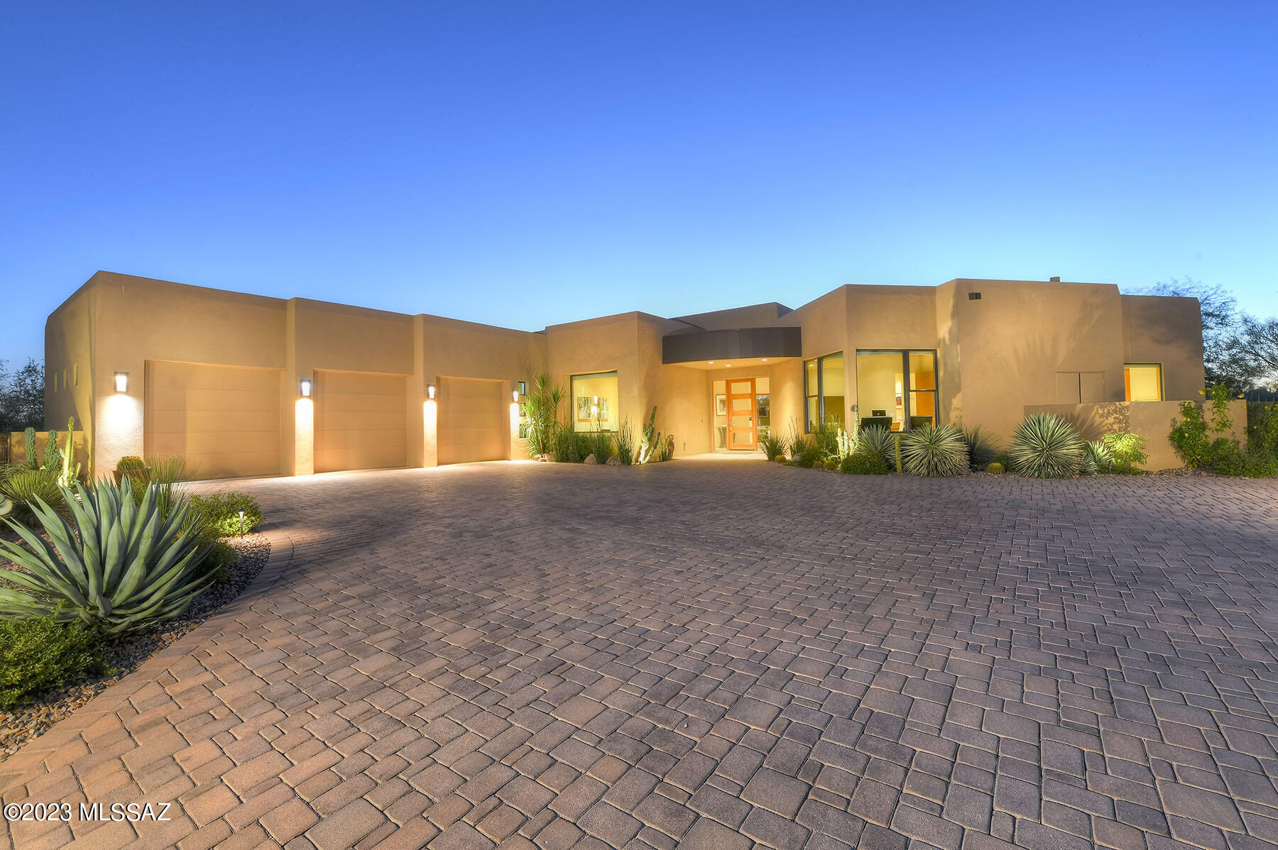 Stunning 2017 soft contemporary, beautifully crafted by Award Winning RB Construction in Ironwood Ridge Estates, an enclave of 8 custom homes on acre+ lots.  Privately located behind massive handmade iron gates for maximum security and backing up to a 14.88 conservation zone, this 4 bedroom, 3 ½ bathroom bath home is nestled on a 1.37 acre lot within a forest of ironwood, palo verde and mesquite trees.  In like-new condition, this lightly used, 3,328 sq. ft. , one story home has no stairs or steps.  Features include European paver driveway and rear porch walkways, covered entry leading to foyer and 21' X 24' great room with soaring ceilings, walls of windows, dramatic contemporary fireplace with LED recessed lighting.  Custom open and flowing floor plan offers formal dining room, custom cabinetry throughout, the finest finishes including gourmet kitchen with Bosch 36" cooktop, SS refrigerator, double oven and Typhoon Bordeaux granite countertops, center island with breakfast bar and breakfast area.  Split floorplan, gracious primary suite with glorious primary bath, walk-in glass shower,  soaking tub, walk-in closet with built-ins, ceiling fans throughout and expansive 3-car garage with epoxy floor.  Wonderfully landscaped yards with trees, built-in BBQ, porches with sun shades, fire pit with banco seating and again, backing up to the conservation easement.  See to appreciate.