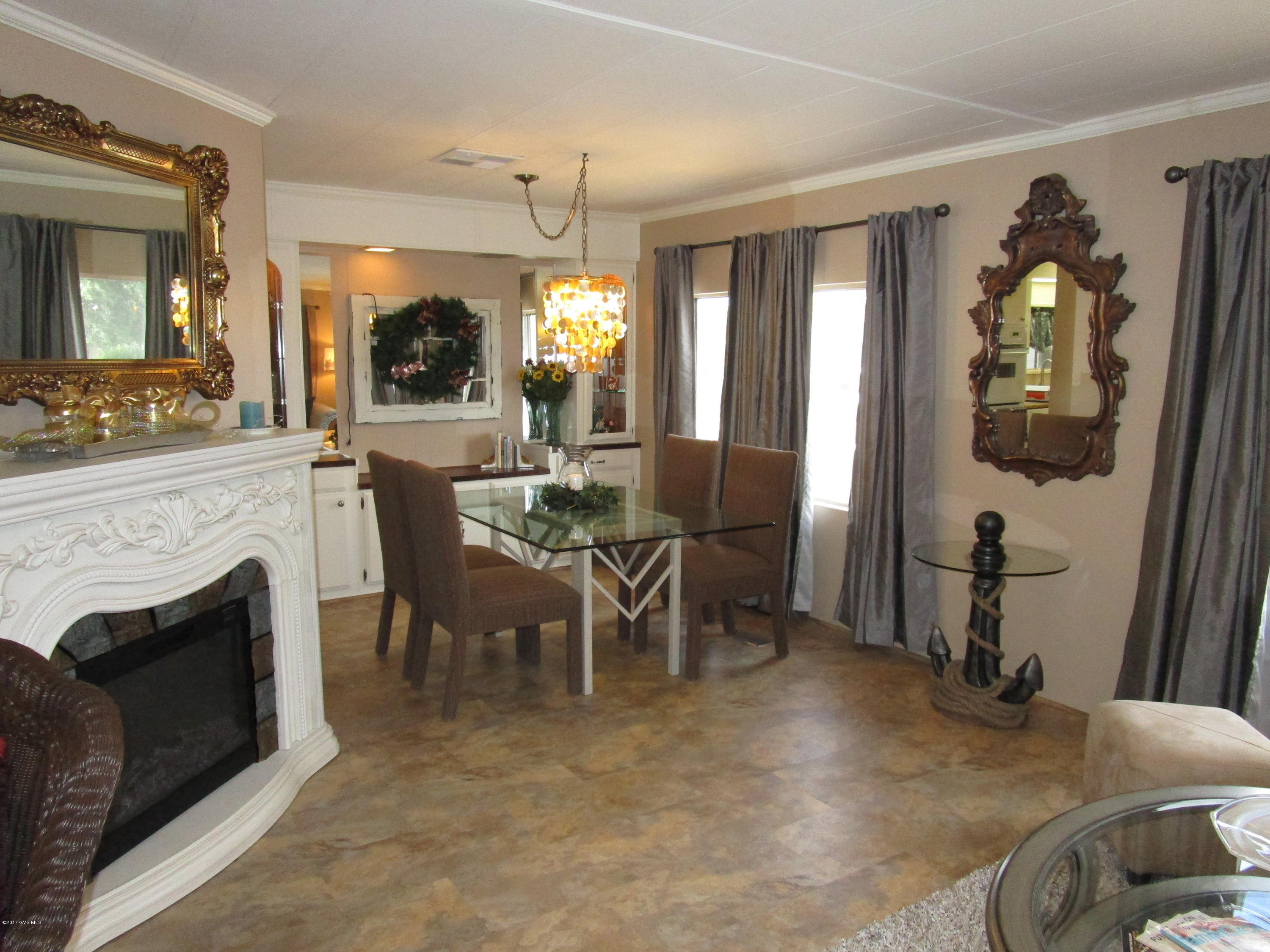 Completely updated-just move in & enjoy! Designer touches abound starting with the fresh paint, Armstrong Lux Tile throughout, new ceiling fans & upgraded light fixtures, new stainless steel side by side refrigerator & electric cooktop & range hood, newer dishwasher, comfort height toilets, new HE washer & dryer. Guest bath has custom tile vanity with matching shower surround. All plumbing redone, heating & cooling 3 years old. This home also has an Arizona room with painted concrete floor & solar screens, & a studio/workshop. Solar screens on most windows and new window coverings. There are two covered patio areas with mountain views from the great room & patio; manicured landscaping with grapefruit & crab apple trees as well as two producing grape vines. Walls sheetrocked, no paneling.