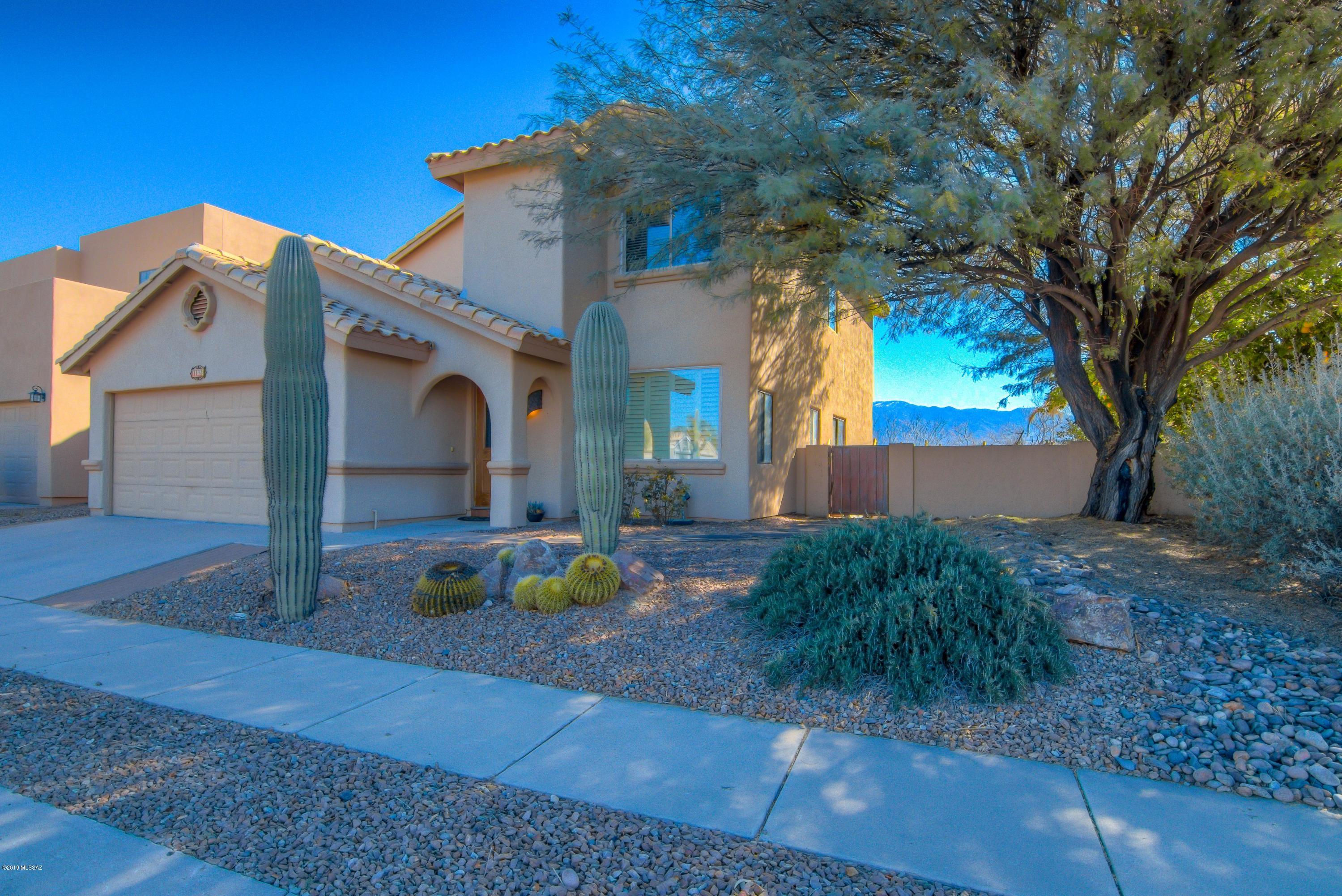 This spacious Oro Valley home with spectacular Catalina mountain views and a pool in the desirable Copper Creek Subdivision. Boasting an open floorplan, 3 bedrooms plus Study (easily big enough for a 4th bedroom) 2 car garage, ceiling fans, & updated kitchen. Relax in your large master suite with a sitting room/office area and your own fire place. The beautiful beehive fire place down stairs is the perfect place to gather around in your family room, or enjoy life outside in your sparkling pool or on your balcony upstairs enjoying the views. Conveniently located near Copper Creek Elementary, OV Marketplace, Catalina state park, biking trails and so much more! No poly pipes here, call this wonderful home yours today. VA assumable loan available.