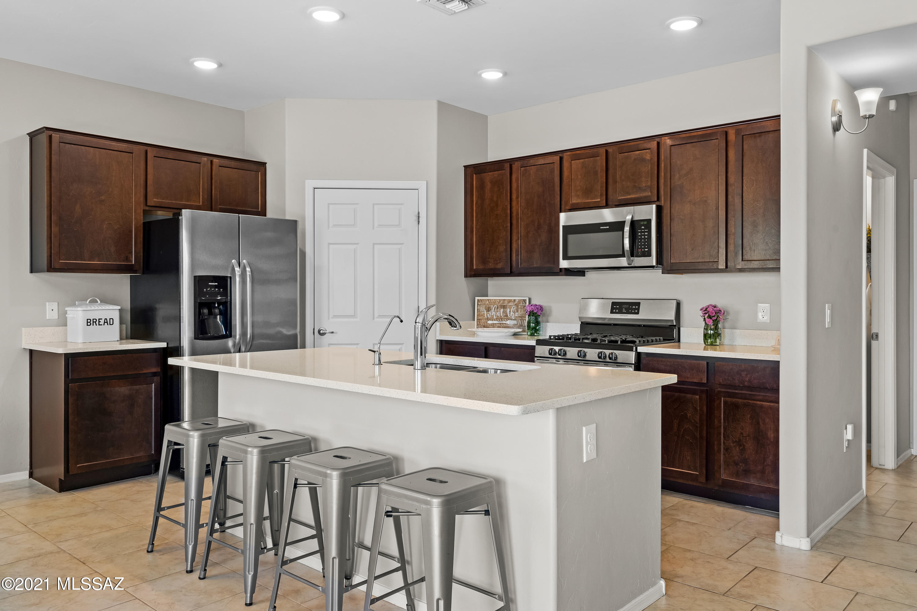 This Beautiful home in the Abrego neighborhood is minutes away from shopping at Sahuarita Crossing, dining and various activities. Open great room off the kitchen creating ample entertaining space with tile flooring and neutral modern color tones with chic fixtures. Modern Kitchen includes Quartz countertops, stainless steel Frigidaire appliances, and a large island with plenty of cabinets and walk in pantry. Spacious master suite with large bath with Quartz counters, double sinks, espresso cabinets. Guest bathroom with Quartz Counters and shower/tub combo. Large loft and flex room downstairs can be used for work office, additional living space whatever you can imagine. This property is gorgeous to look at come make it your home today.