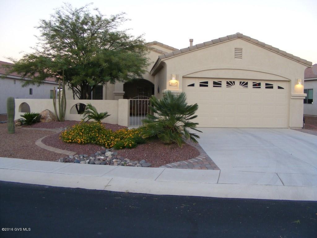 Enjoy sunrise and mountain views from your covered patio which boasts a hot tub for two and an upscale bar-b-grill with a refrigerator! Inside this home just flows with a just the right sized kitchen and breakfast bar, great room and dining area, office/den with glass French doors and a master bedroom with a LARGE walk-in closet and split vanity/sinks in Master bath! You will love the shady front courtyard in the late afternoons to relax and let the world go by! Golf Course and Grill approximately a mile down the street and the largest GVR Center in Green Valley is available to you in Santa Rita Springs with exercise room, camera club, Olympic size swimming pool and all kinds of activities, in addition to the local pool and spa. Furnishings available per inventory, by separate bill  of sale separate bill of sale. Owner willing t do a Seller carryback with acceptable credit report and reasonable amount of cash down, for up to five years.