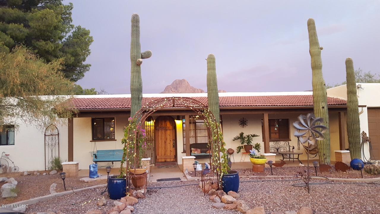 History! Privacy! Serenity! Unique property opportunity minutes from convenient shopping & I-10 access. Imagine 1946 converted Signature 6 Ranch bunkhouses nestled amidst scenic desert vistas, under the shadow of the Tucson Mountain Range. Almost 3.4 acres of horse property offer unparalleled views w/private bricked patios, covered front porch, Mexican tile floors, updated kitchen, fireplace, sculptured mural, ''History of Tucson'' by artist Linda Hayworth, mature shade trees, rainwater cistern & so much more. Nearby, enjoy Sanctuary Cove, Saguaro National Monument, hiking, horseback riding trails, birding. Live the outdoor lifestyle in this amazing Old Pueblo home.