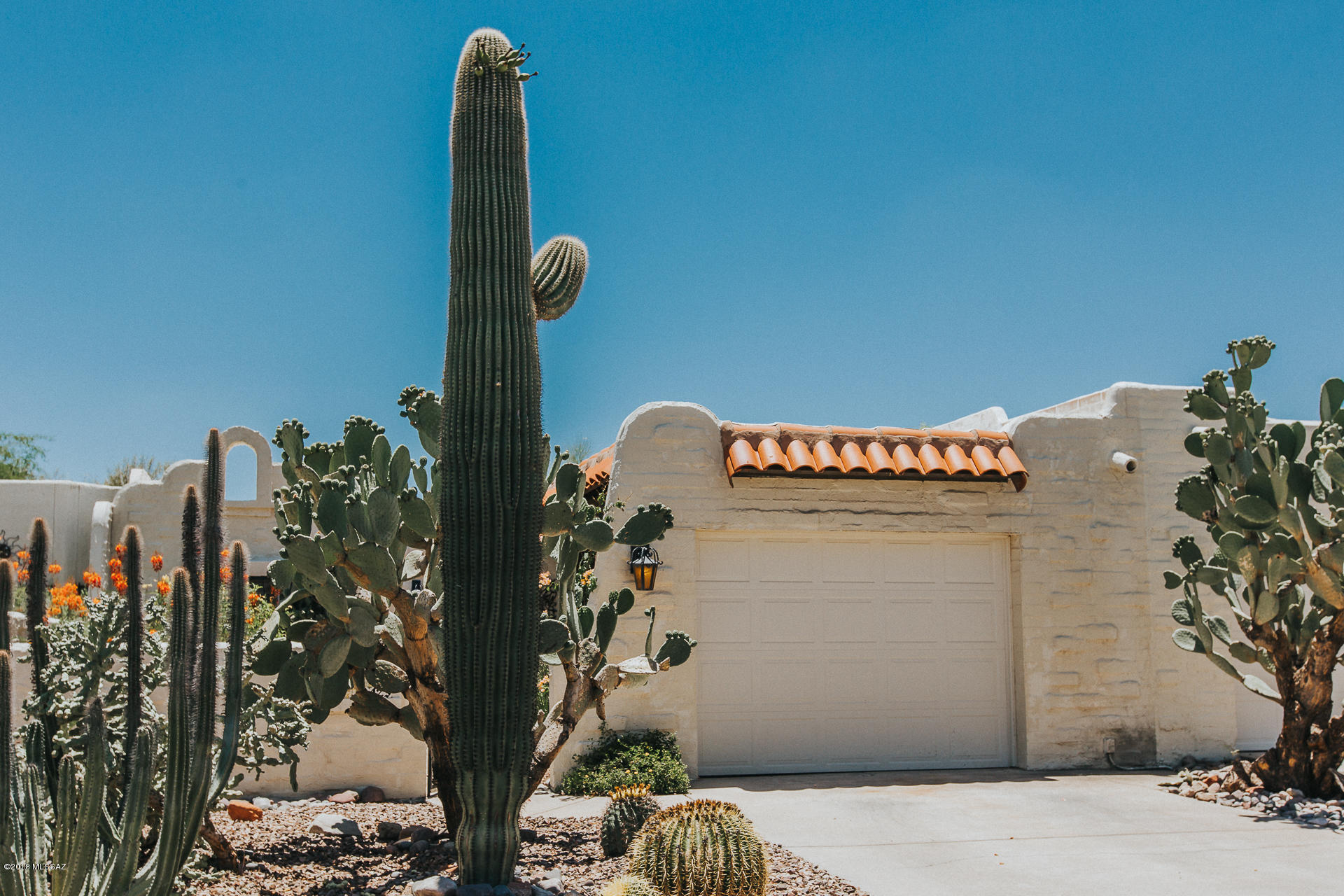 Incredibly charming townhouse with a private pool, a beehive fireplace and Mexican tile throughout. Open kitchen with beautiful titled counter with newer stove and dishwasher. Both bedrooms are nice sized and both bathrooms updated. HVAC is 3 years old and the roof has been recoated 2 months ago. Garage door is new. Come and see this wonderful home today!