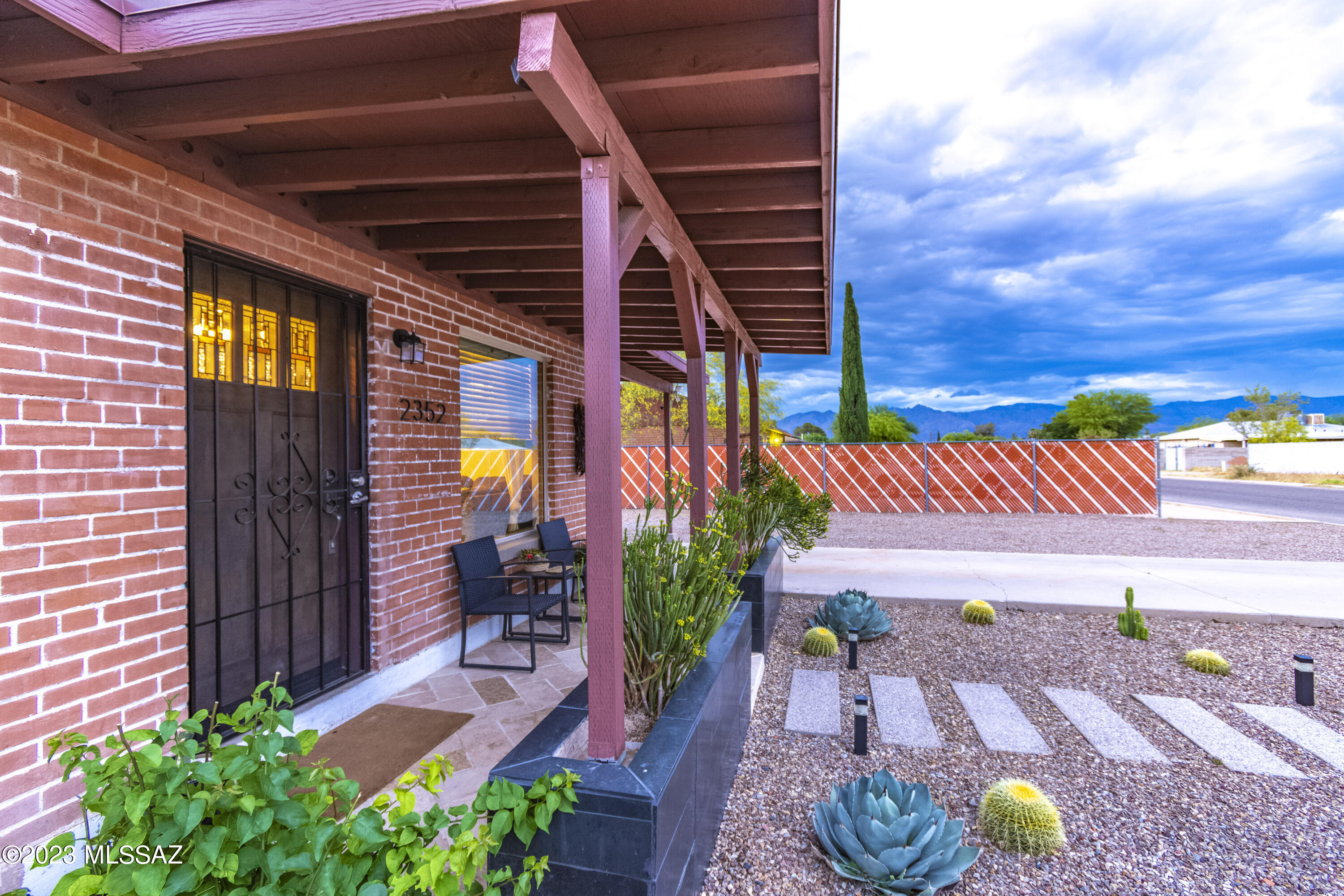 This house is the absolute gem of the neighborhood and shines among the rest with its modern curb appeal. Meticulously reimagined by a certified designer, interior boasts a spacious open concept living room and kitchen that leads to a bonus multi-use space. Wood-look porcelain tile flooring throughout the main areas and tumbled limestone in all 3 bedrooms will captivate you. A culinary enthusiast's dream, the kitchen showcases modern appliances, granite countertops, large island, enchanting backsplash tile, gas range, built-in wine bar, new cabinets and recessed can lighting.  Living room invites you to relax with its custom stone veneer wall and built-in electric fireplace. Gorgeous bathroom was completely transformed with a new quartz countertop vanity, contemporary floor to ceiling ---> backsplash, can lights, glass shower panel, & an enormous 3 paneled mirror with built in storage and ambient lighting. The backyard is built for entertaining featuring new turf, large pavers, new corrugated metal fence and an enclosed dog run. 12x20 foot fully wired to code gazebo with ceiling fan, built-in Jenn-air barbecue and Blackstone, large bar, TV mount, surround speakers, and string lights around the perimeter. Adjacent to the gazebo is a stone veneer firepit with string lights and shed with built-in shelves. This lush oasis showcases 2 mature orange trees, 2 pomegranate trees, a lemon and lime tree with irrigation. Large side gate providing plentiful storage and access for toys. Enjoy being minutes from shopping, schools, parks, and a convenient central location minutes from Davis Monthan AFB, Aviation Highway, and much more. With no HOA, you do not want to miss out on the opportunity to make this your home!