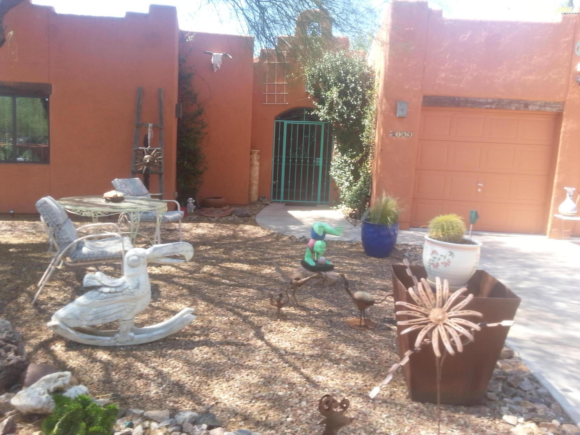 Beautiful Santa Fe style house located on a 1.68-acre lot. It has 3 bedrooms and 2 baths and has 1968 square feet of living space. All of the appliances stay including stove, refrigerator, microwave, dishwasher, washer and dryer. It has dual cooling and heating units. The master suite has a bee hive fireplace with kiva beams. The living room has a bee hive fireplace with high ceiling and kiva beams. It has a 2-car garage. The yard is beautifully landscaped with desert plans and large trees. The front of the yard has a metal entrance gate with a courtyard wall and the rest of the yard is fenced with metal fence and beautiful gates. It is about 50 miles from Tucson and about 5 miles from a shopping center. It is very private with beautiful views.